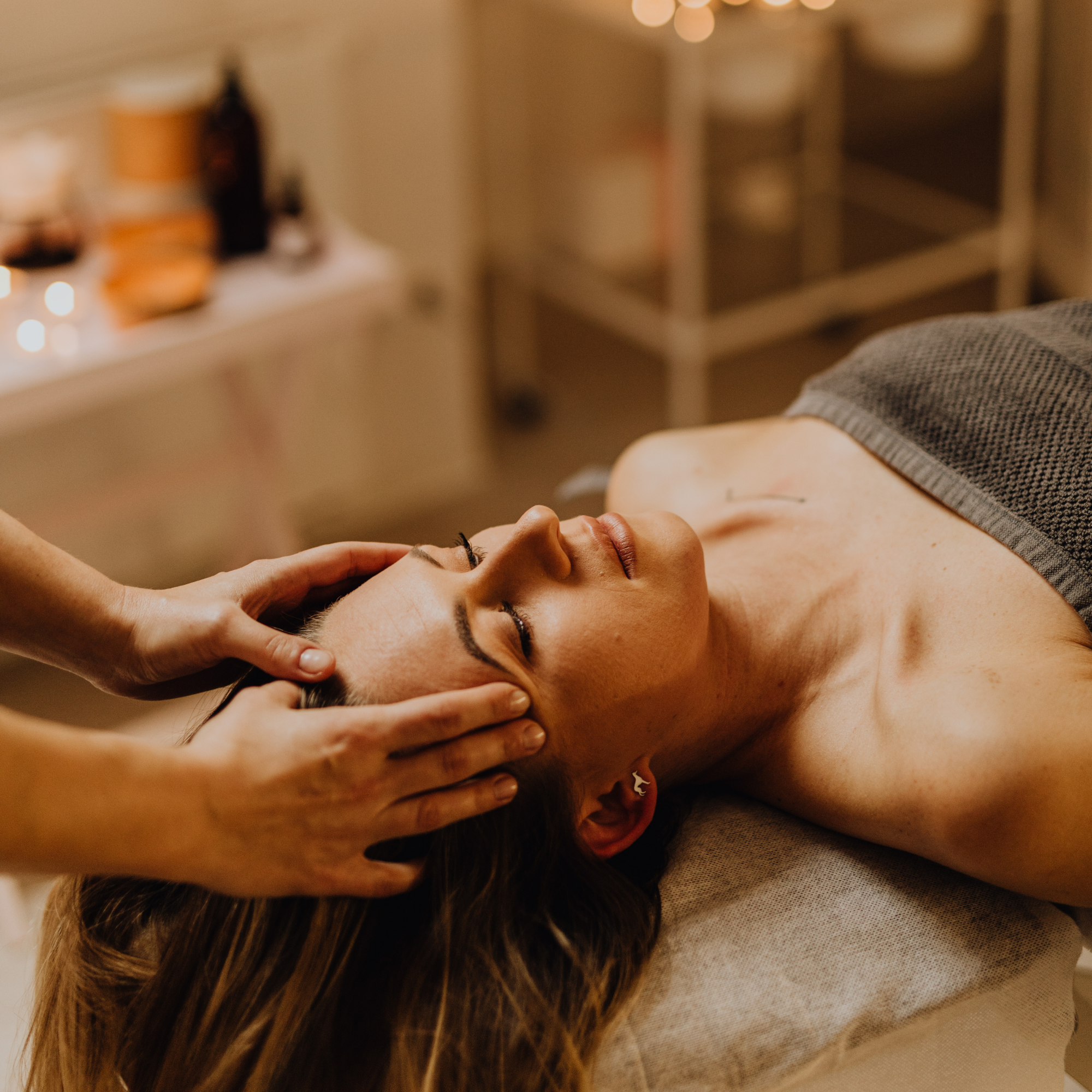Person receiving a neck massage in a wellness setting