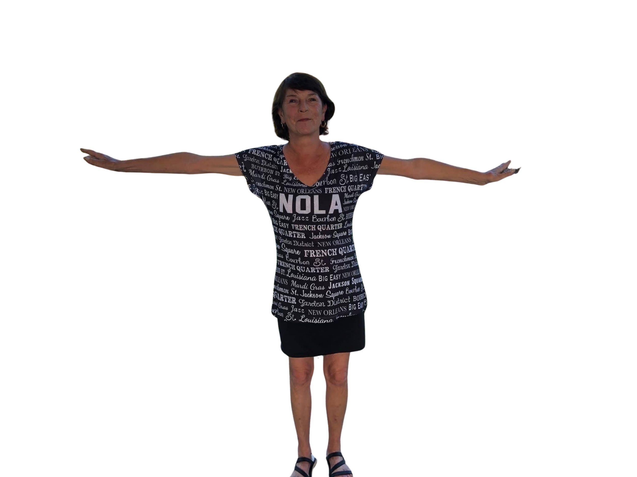 A woman standing with arms outstretched, wearing a dress with words referencing New Orleans and phrases like 'JAZZ,' 'FRENCH QUARTER,' and 'BIG EASY.'