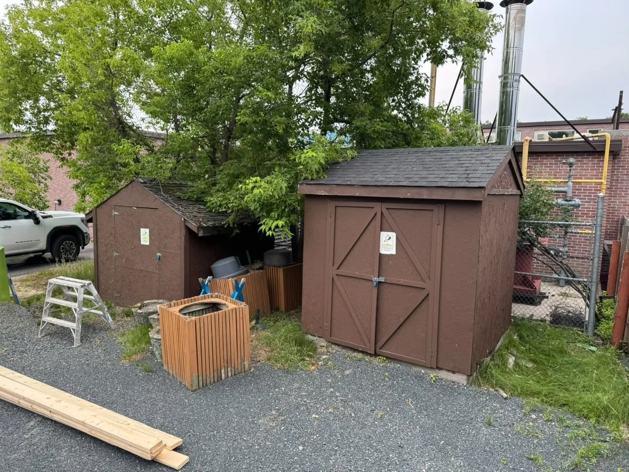 BEFORE Sheds: stripped shingling and new sheathing. New shingles and fascia. From old brown to new sleek grey and black - Pincrest carehome (2026)