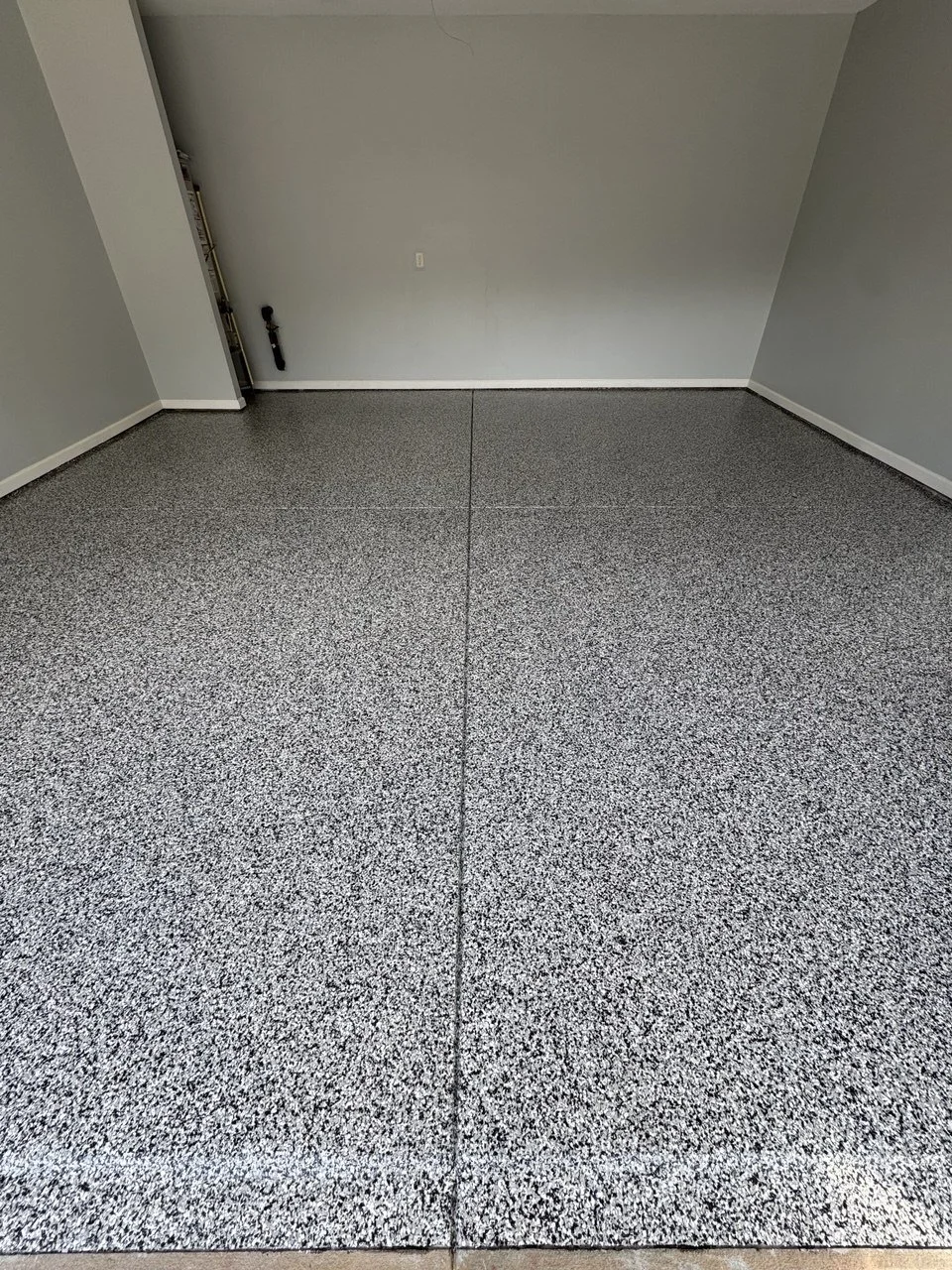 Empty room with gray flake epoxy flooring
