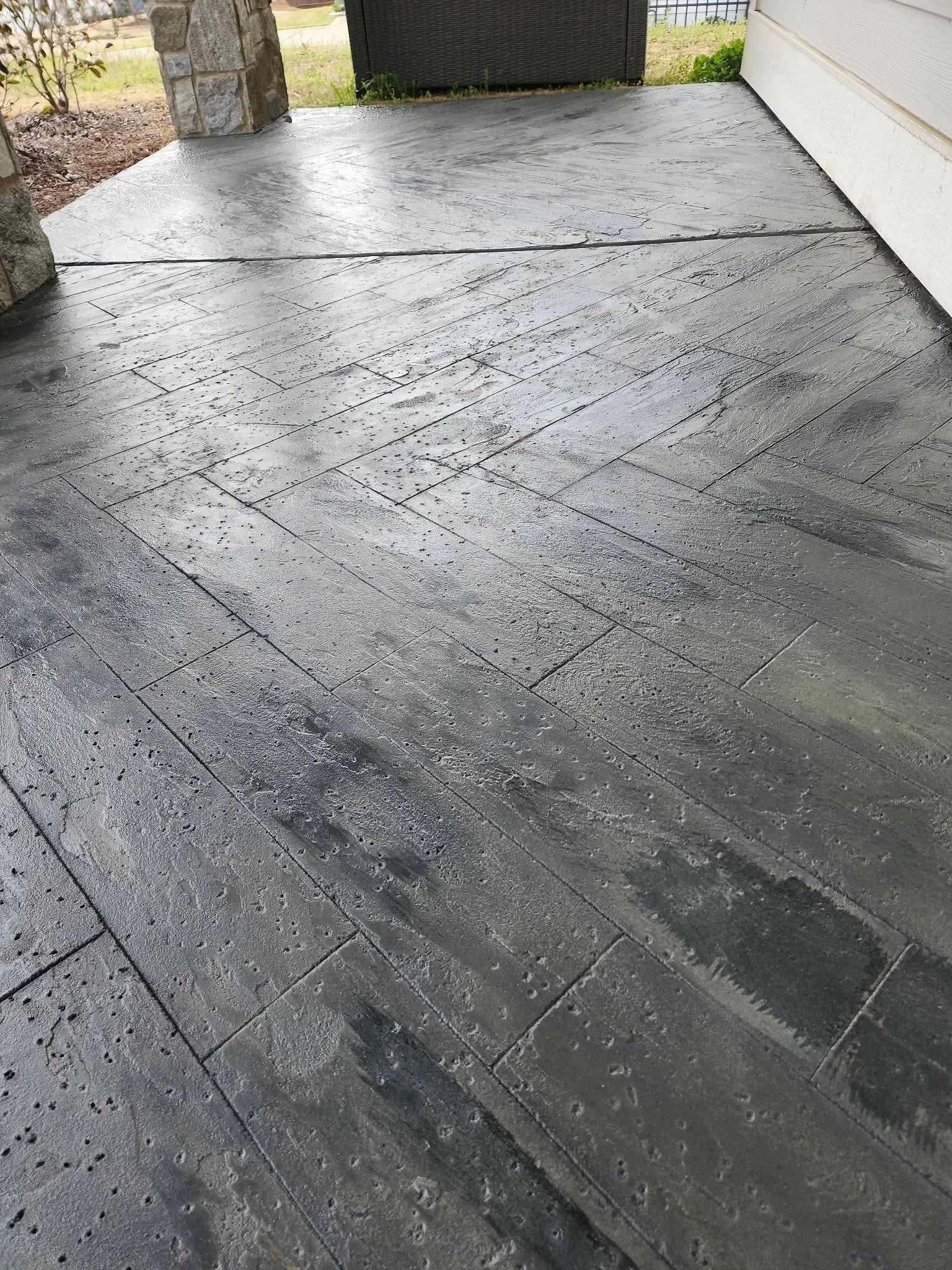 A concrete porch with a stamped concrete surface