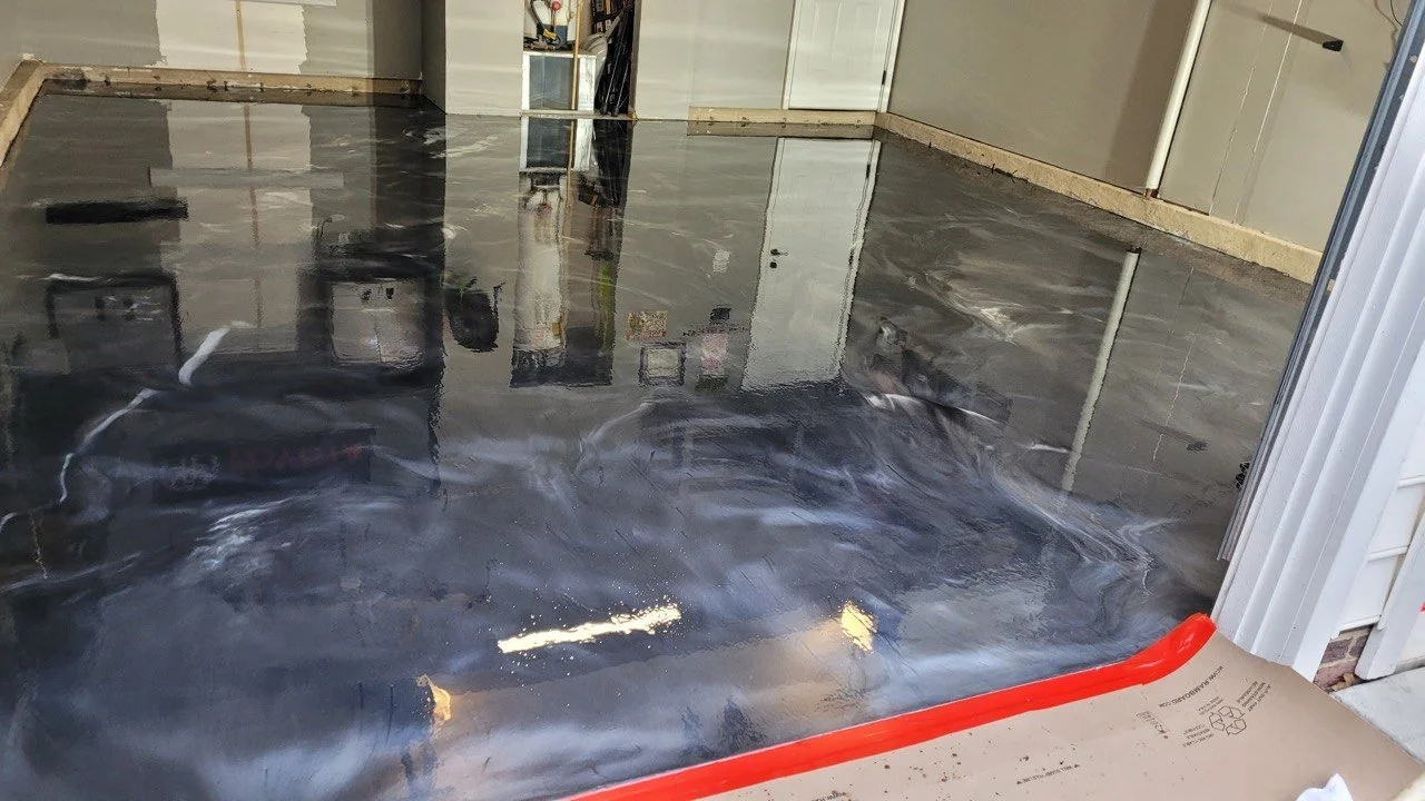 A garage floor with fresh black flake epoxy coating