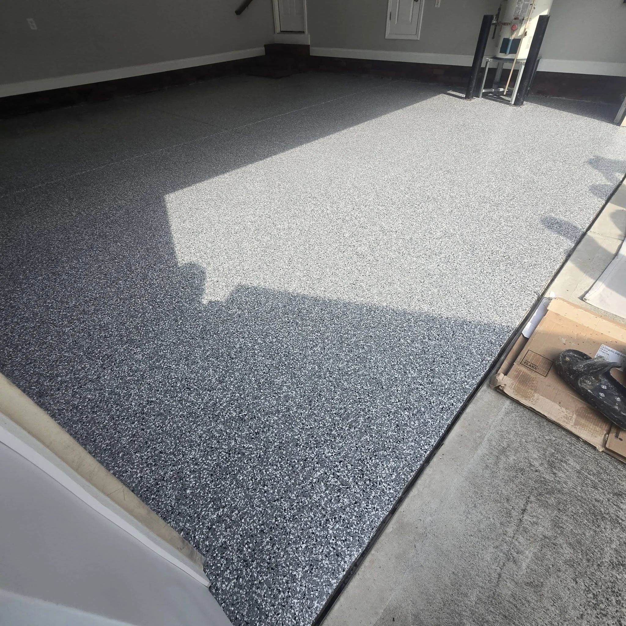Interior view of a room with a newly installed speckled gray flake epoxy