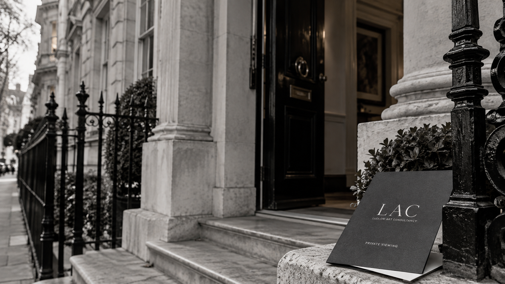Black folder labeled 'LAC Ludlow Art Consultancy Private Viewing' resting on stepped stone steps outside a building with a black iron fence.
