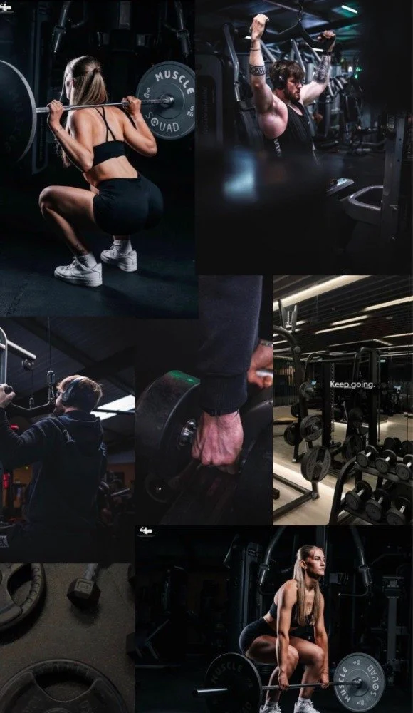 People working out in a gym, lifting weights and using exercise equipment.