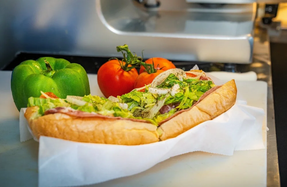 Bottoms Up deli sub piled with meat, lettuce, and fresh toppings
