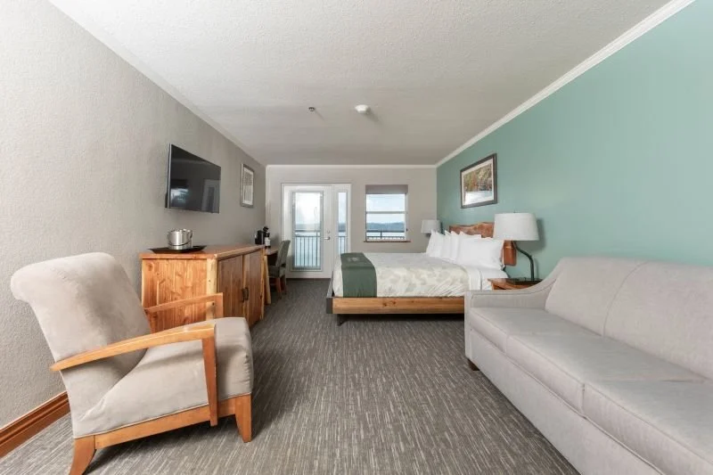Lakeview room with balcony, Accommodates 4. Includes 1 King Bed, 1 Full Size Sleeper Sofa. Wifi, Microwave, Small Refrigerator, Keurig Coffee Maker. Rate: $180/night Senior or Military Discount $162/night