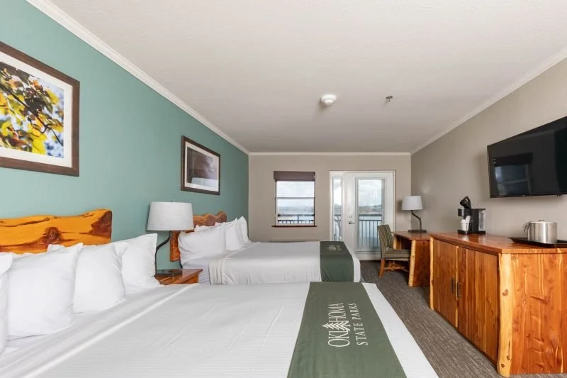 Lakeview room with balcony, Accommodates 4. Includes 2 Queen Beds. Wifi, Microwave, Small Refrigerator, Keurig Coffee Maker. Rate $180/night, Senior or Military Discount $162/night