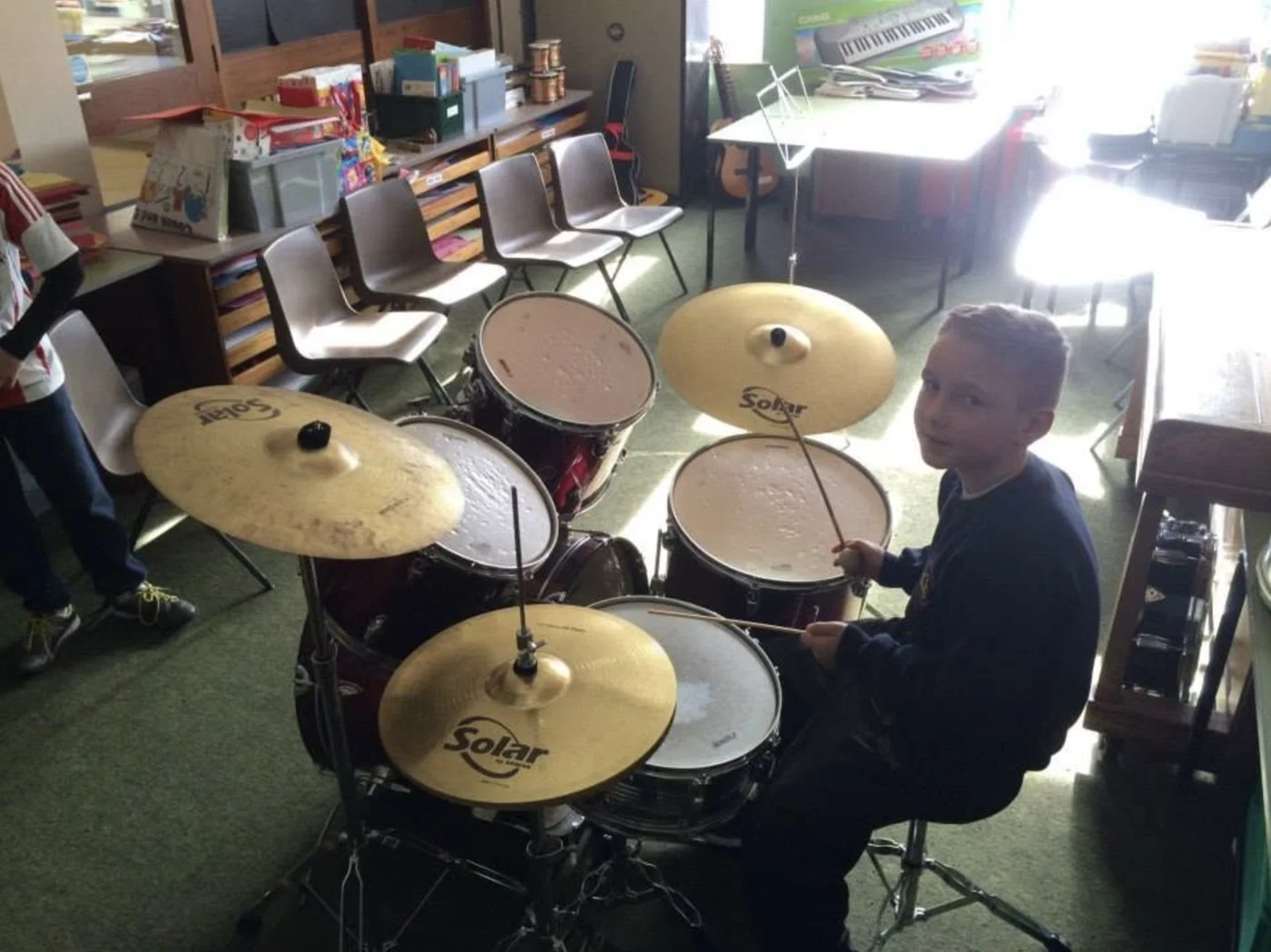 A pupil learning the drum kit