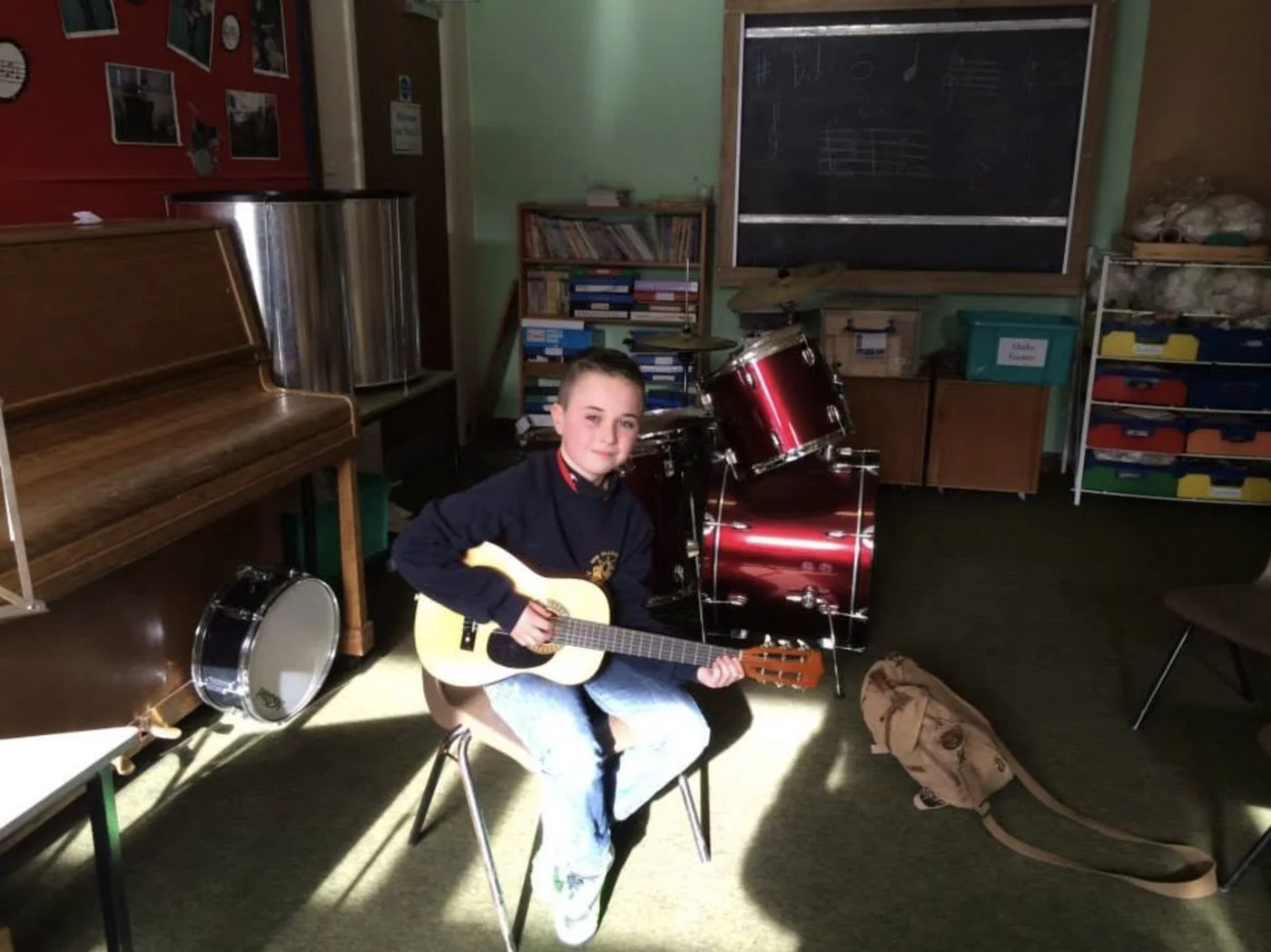 A pupil with his guitar in the music room