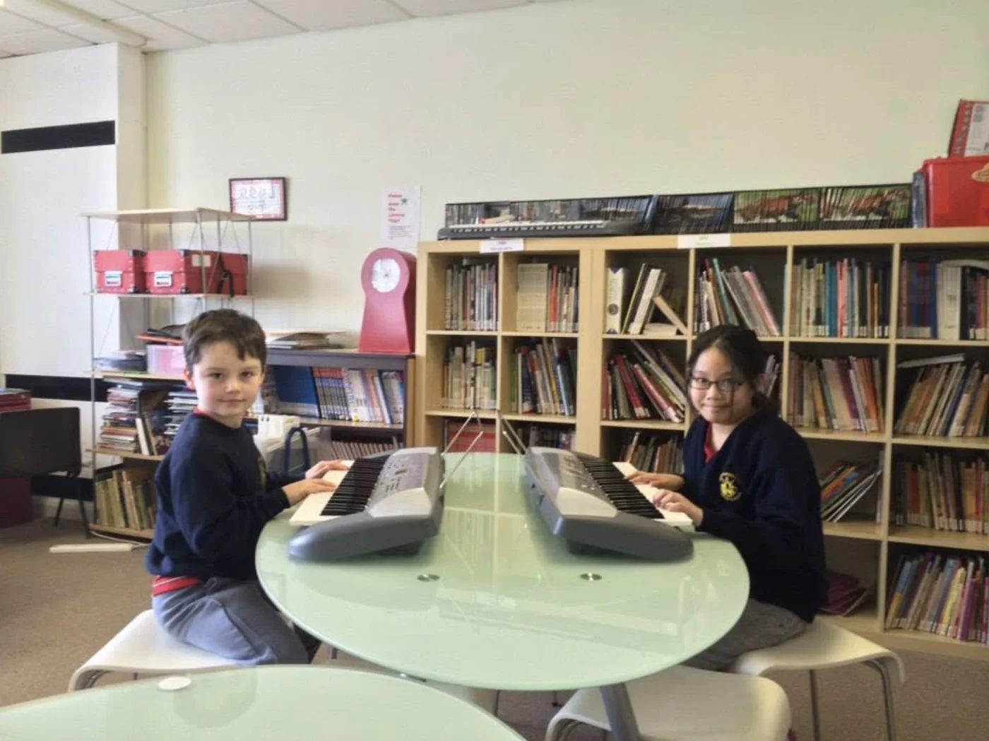 Two pupils playing keyboards