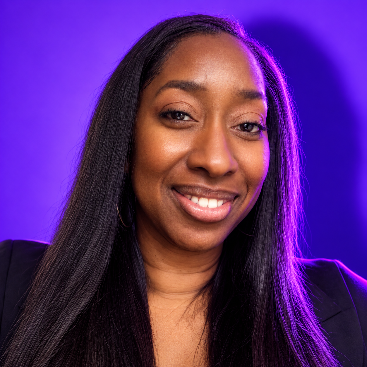 Close-up portrait of a woman with long, straight black hair, smiling, against a purple and blue gradient background.