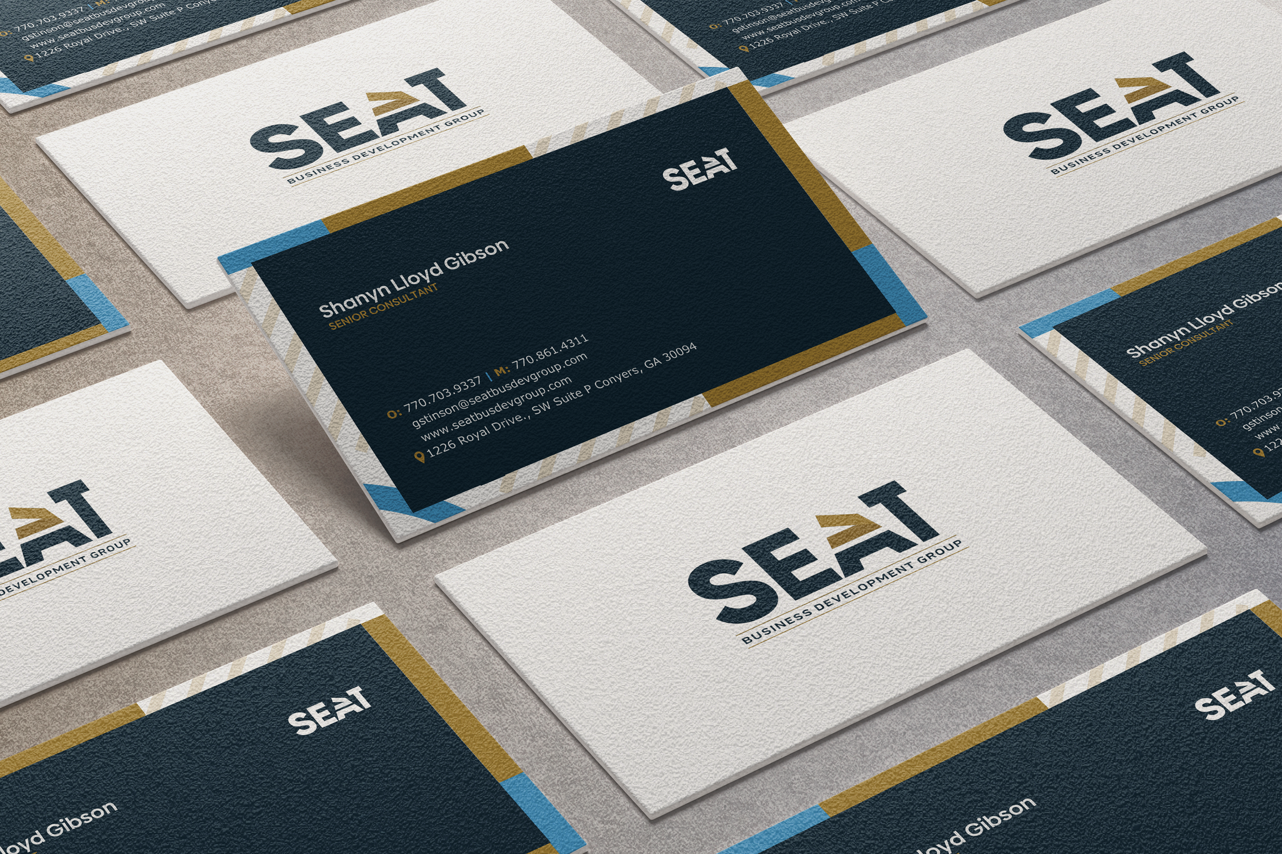 Business cards for SEAAT Business Development Group arranged on a table, featuring name Shannon Lloyd Gibson, senior consultant, with contact details and website address.