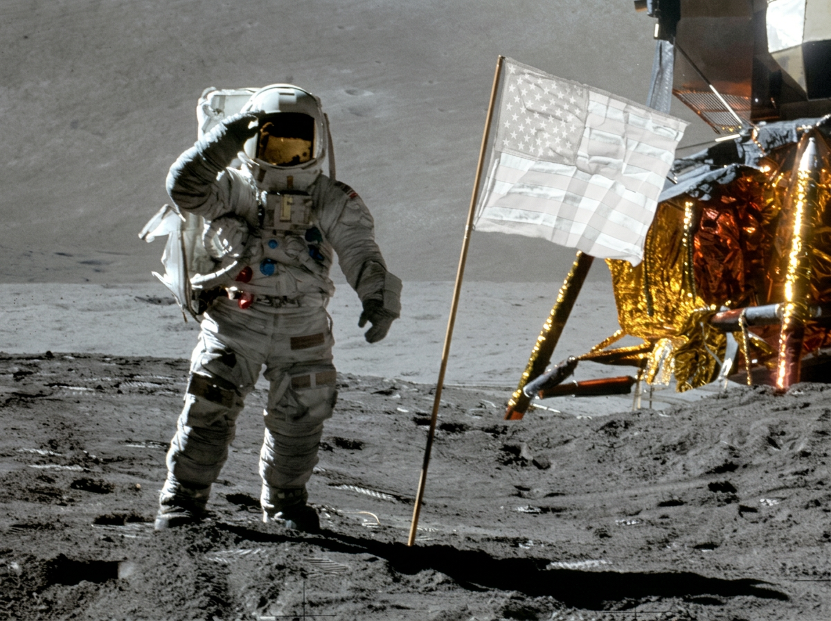 An astronaut saluting on the lunar surface with an American flag and lunar module nearby.