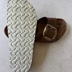 Close-up of a baby shoe showing the sole and part of the strap