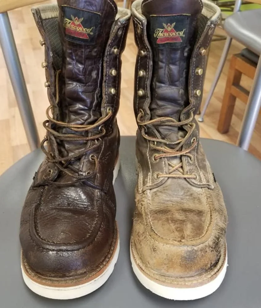 Pair of well-worn brown and tan leather work boots on a chair, with scuffed and creased leather and dirty soles, labeled 'Thoroughbred' at the top.