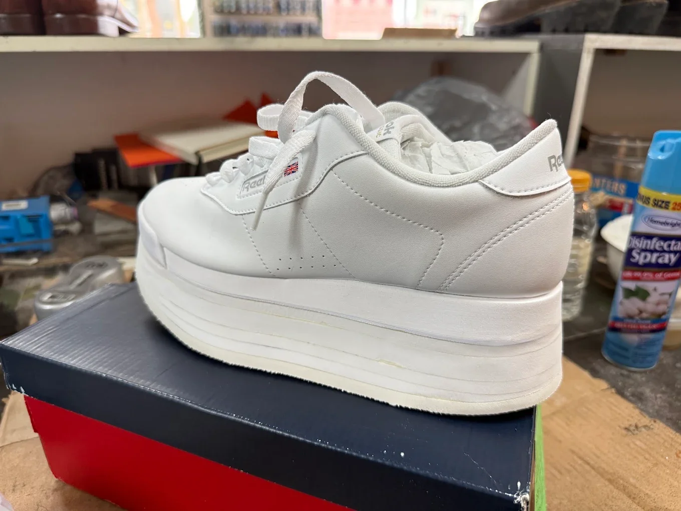 White Reebok sneakers on a shoebox.