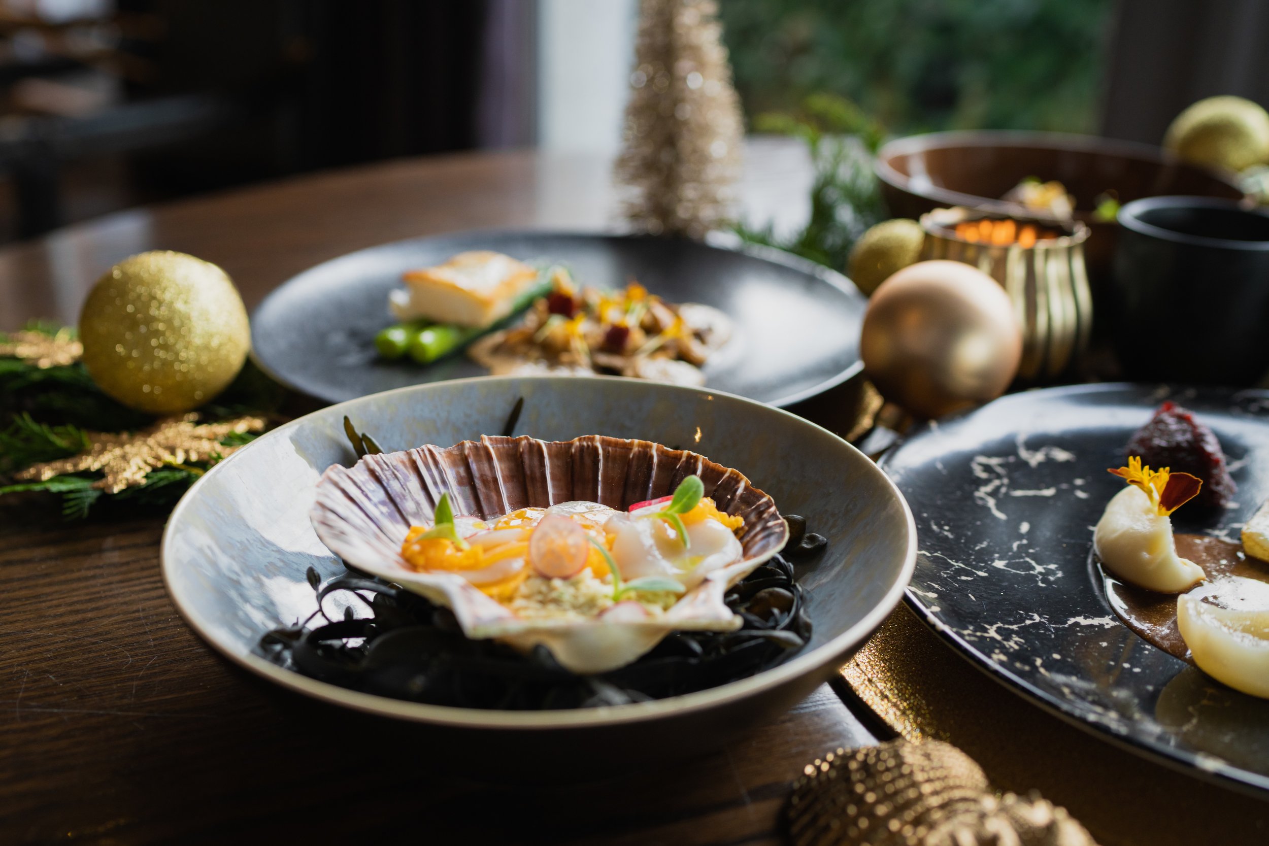 Elegant fine dining experience with delicately plated seafood and scallops, reflecting the sophisticated London dinner dates enjoyed with luxury companion Sienna Blakely.