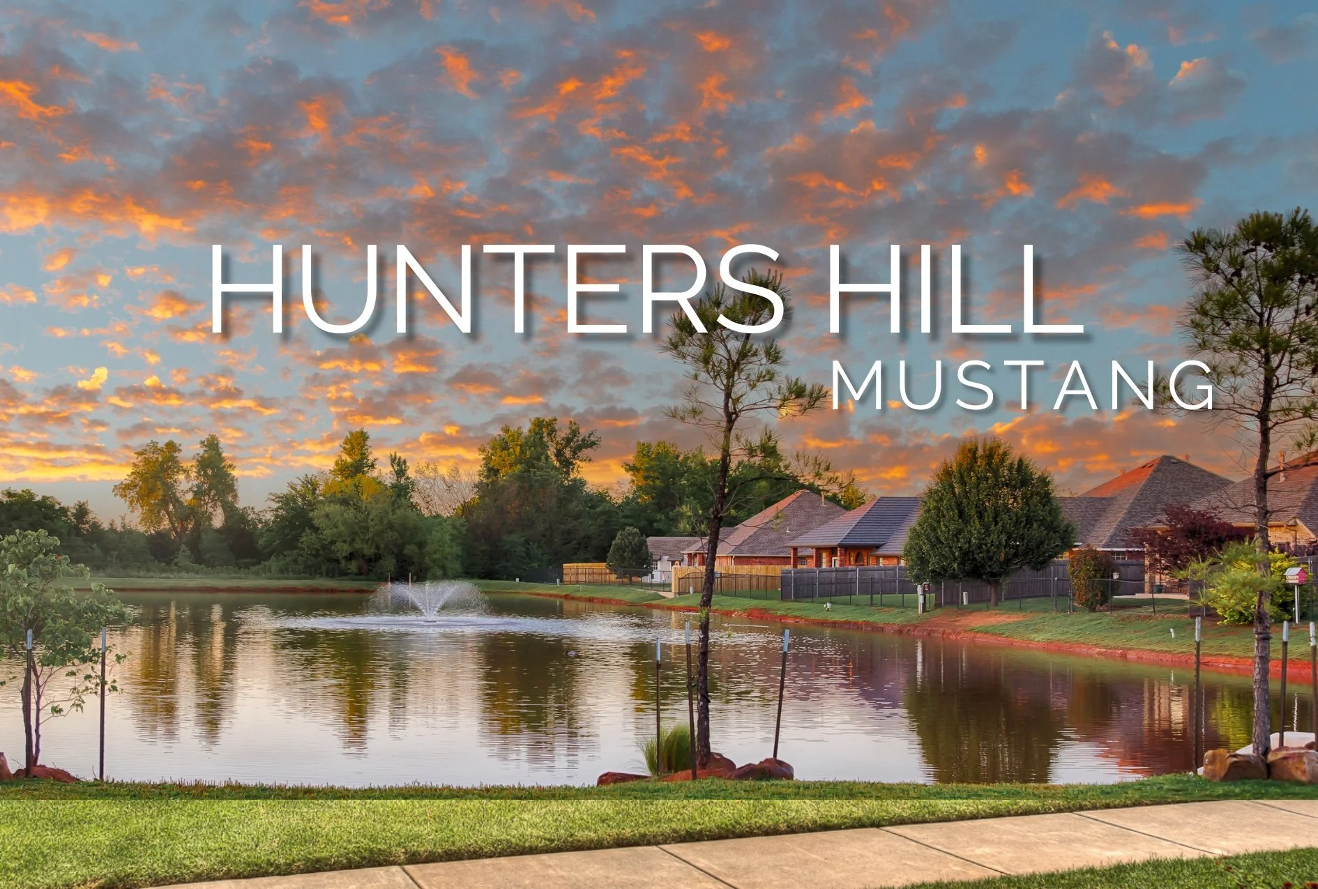 Hunters Hill neighborhood in Mustang, Oklahoma, featuring a landscaped pond with a fountain, surrounding homes, and colorful sunset clouds.