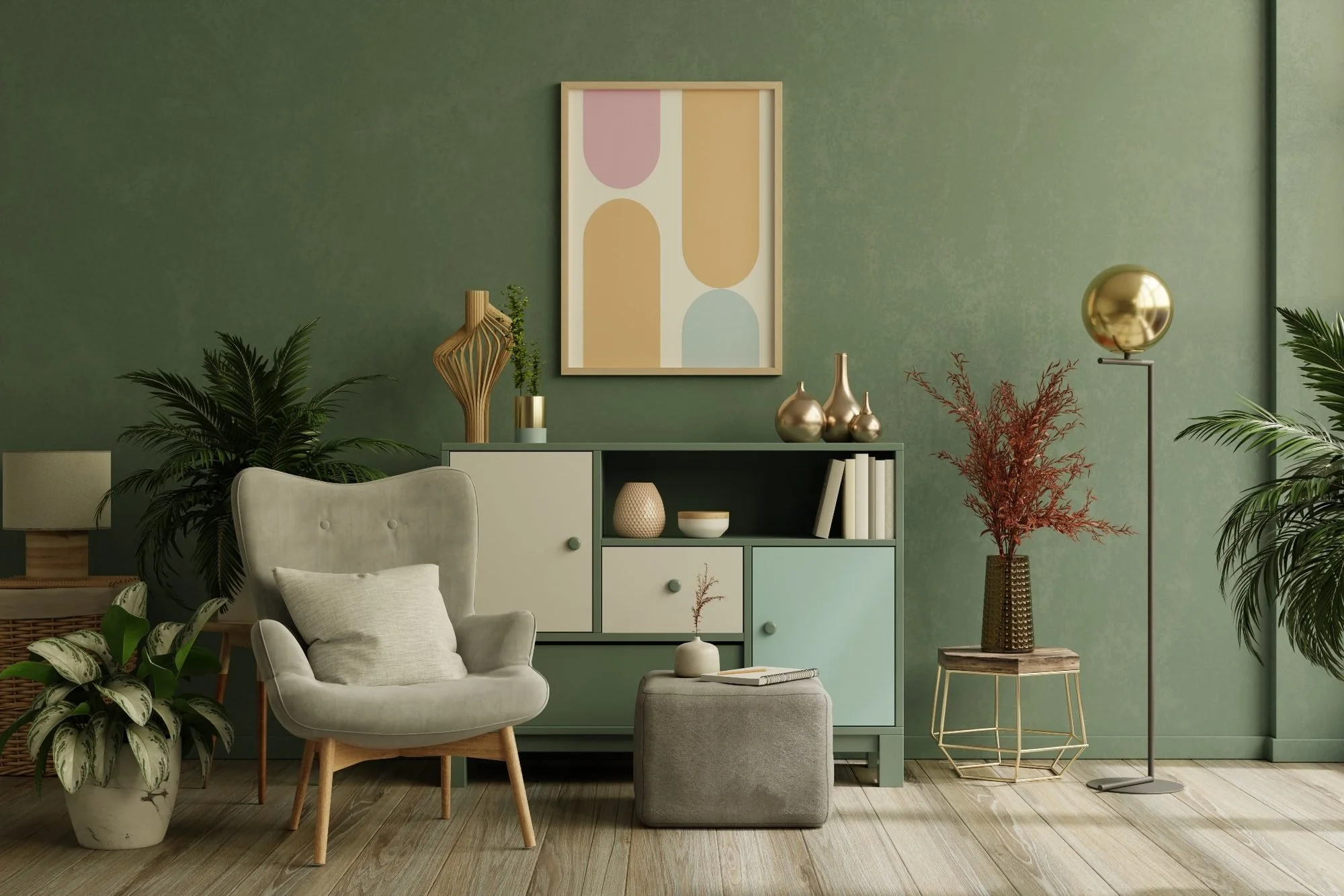 A cozy living room with a green wall, a beige armchair, and a small ottoman with a pillow. There is a light green and white cabinet with decorative vases and books, a large abstract artwork on the wall, several potted plants, and a modern floor lamp with a metallic sphere shade.