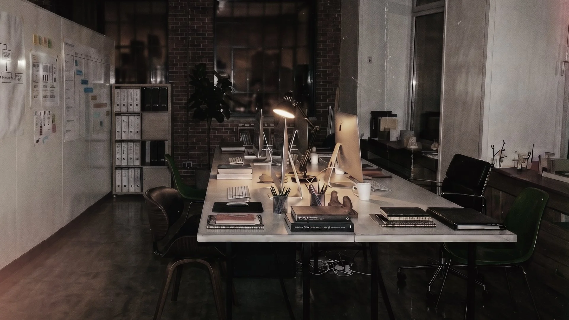Modern design office with computers, desk lamps, binders, notebooks, and office chairs