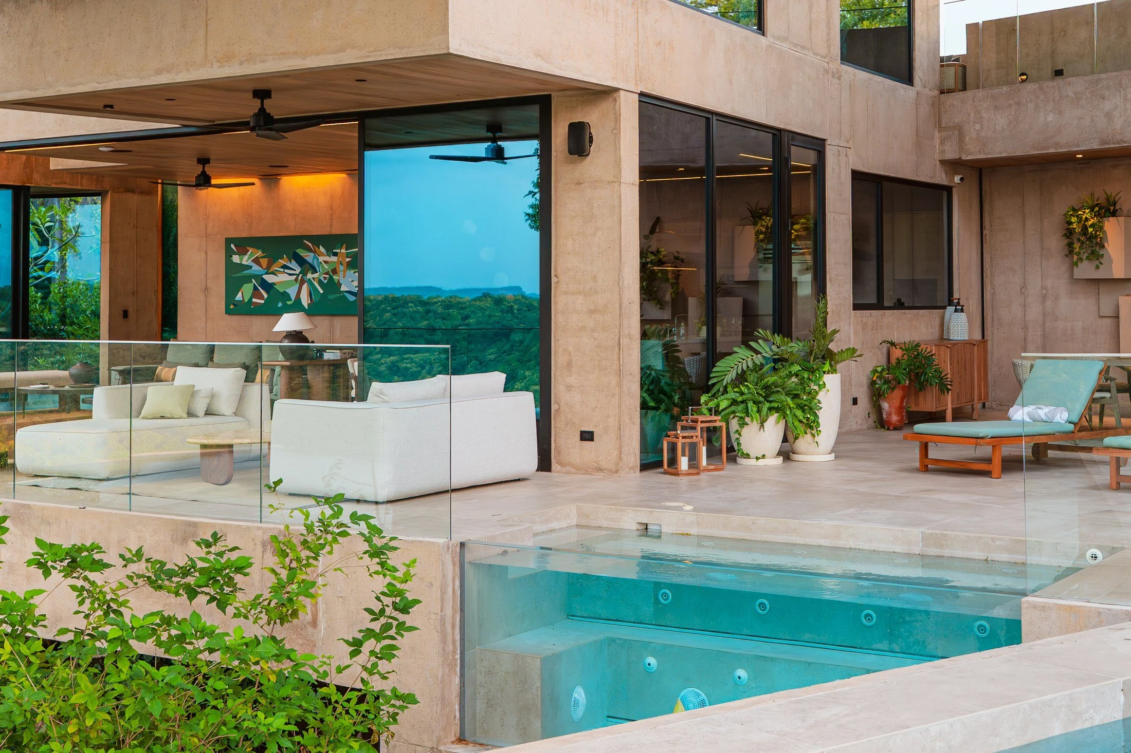 Open living area, terrace and glass-walled pool at a modern villa in Peninsula Papagayo, Costa Rica