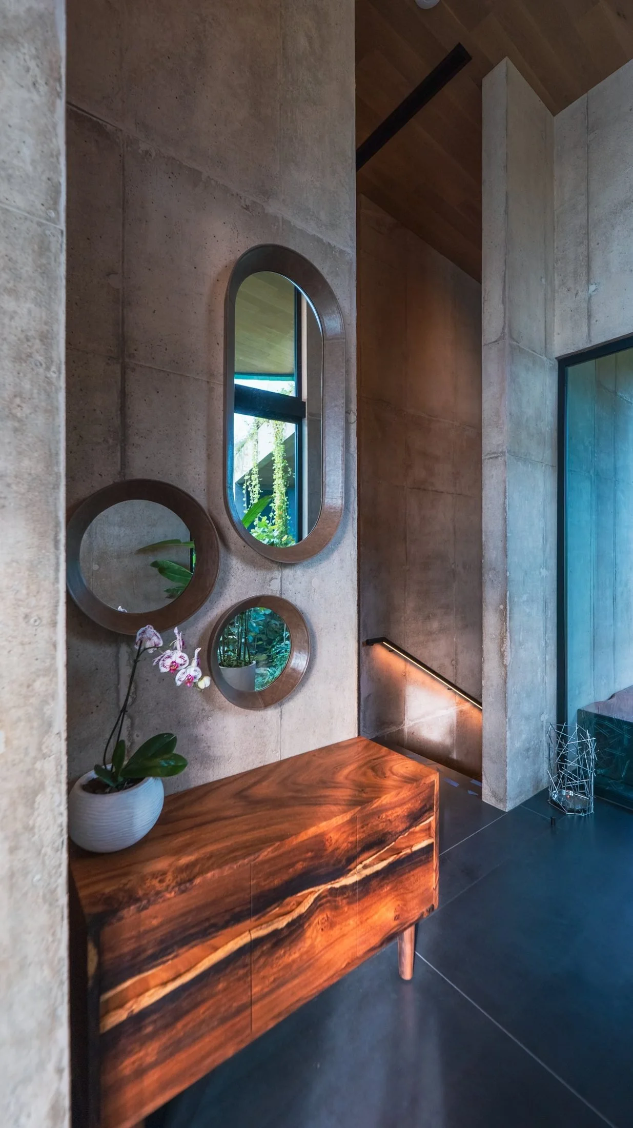 Entry hall with round mirrors and a wood console at Waldorf Astoria Punta Cacique, Guanacaste, Costa Rica