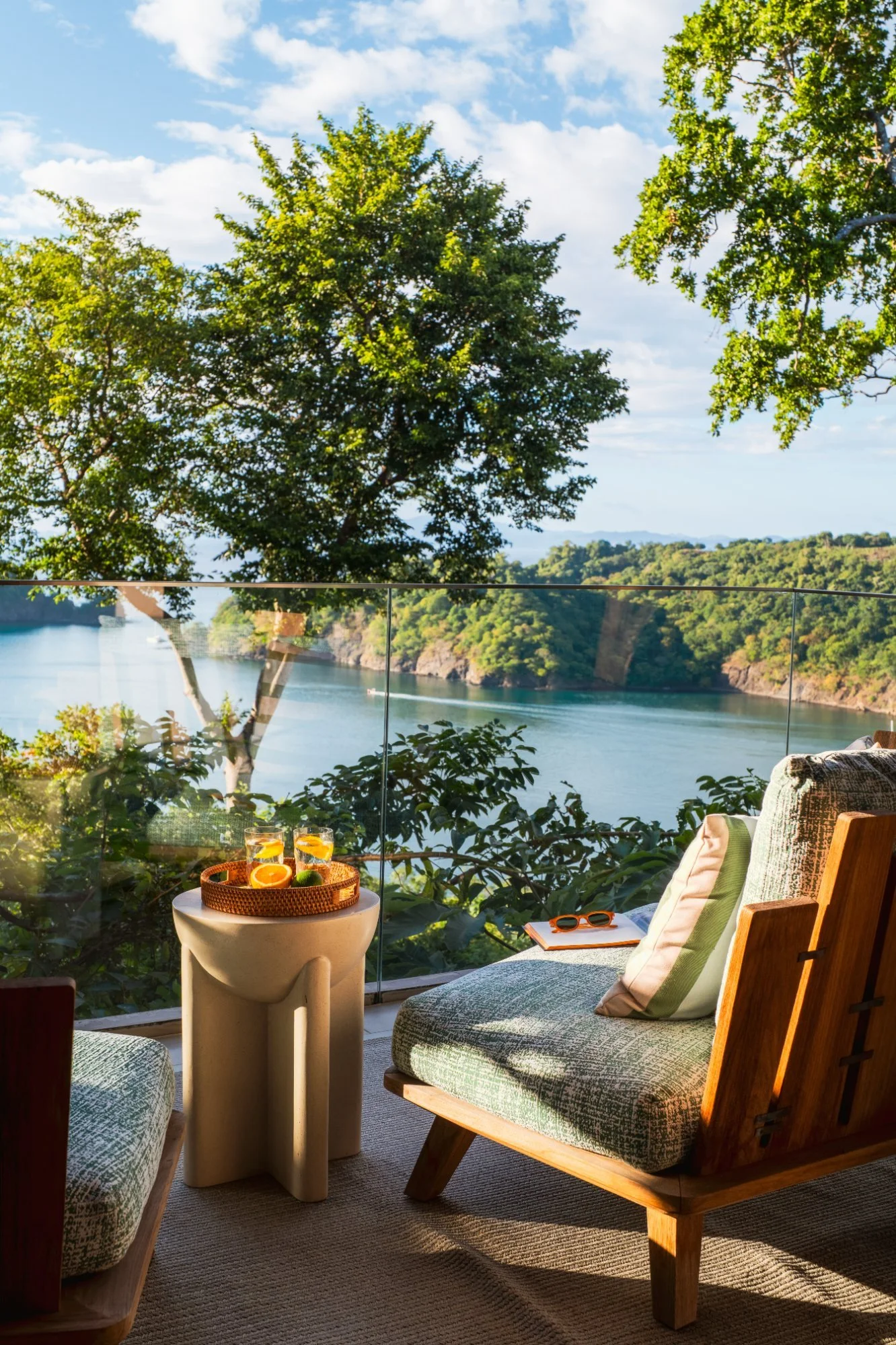 Lounge chairs on a glass balcony overlooking the bay in Peninsula Papagayo, Costa Rica