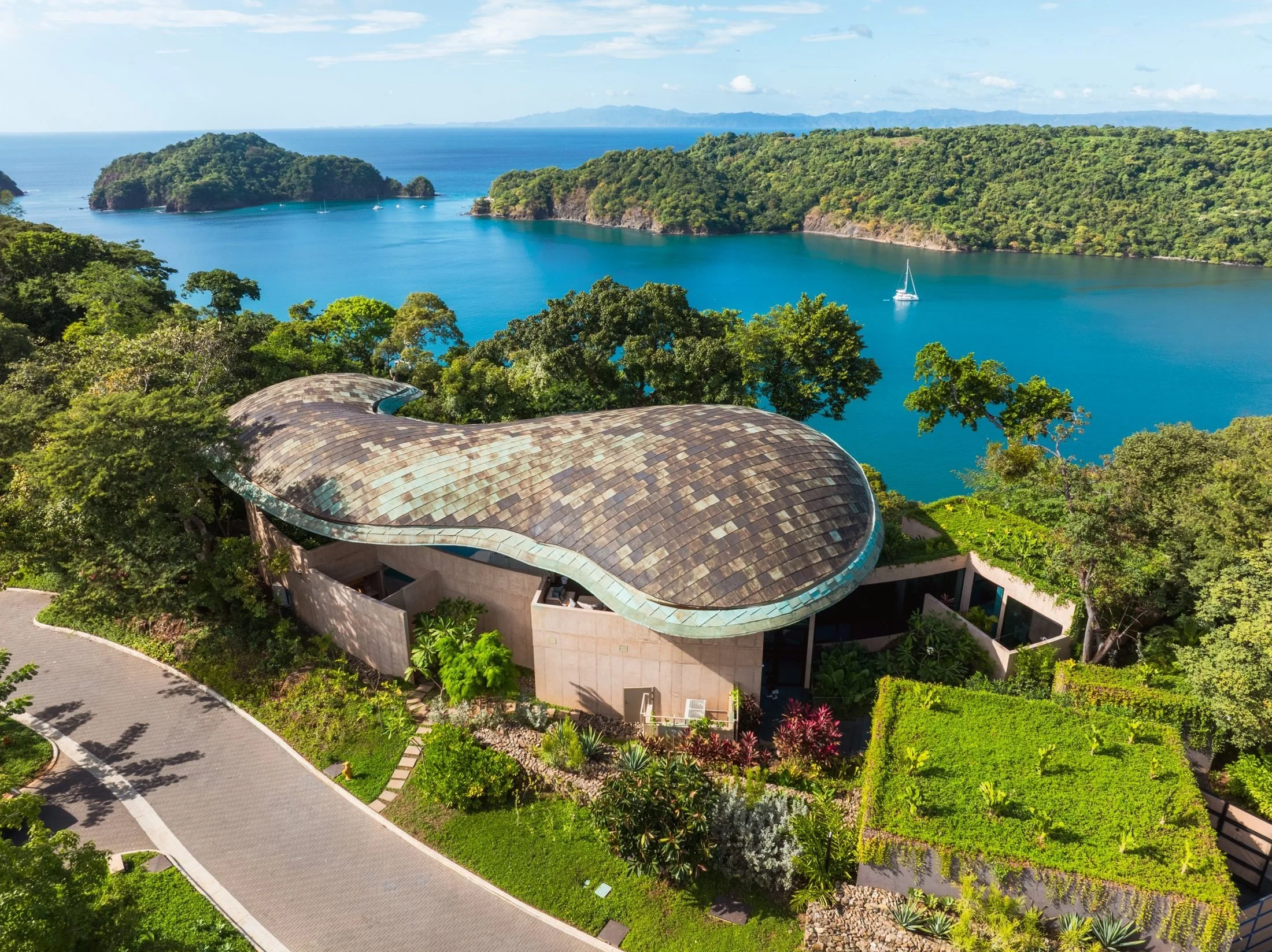 Aerial view of a luxury villa with a copper roof above the bay in Peninsula Papagayo, Guanacaste, Costa Rica