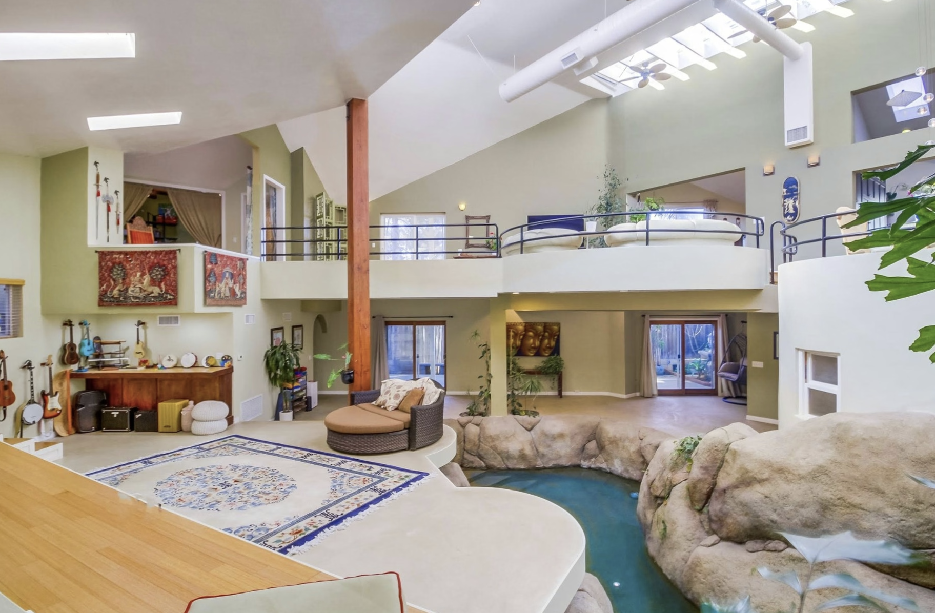 The indoor pool and two-story waterfall inside Rob Wellington Quigley’s Johnson Residence at 1876 Sefton Place, Point Loma, San Diego.