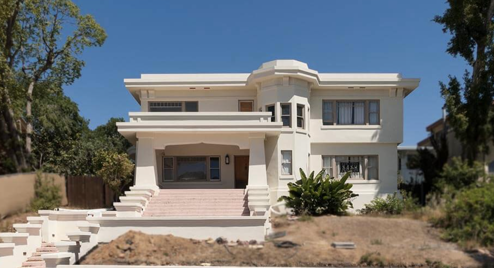 The 1928 Spanish Eclectic Bradt/Melhorn Spec House at 1115 Alberta Place in Mission Hills, San Diego, with its stucco front and arched wood door.