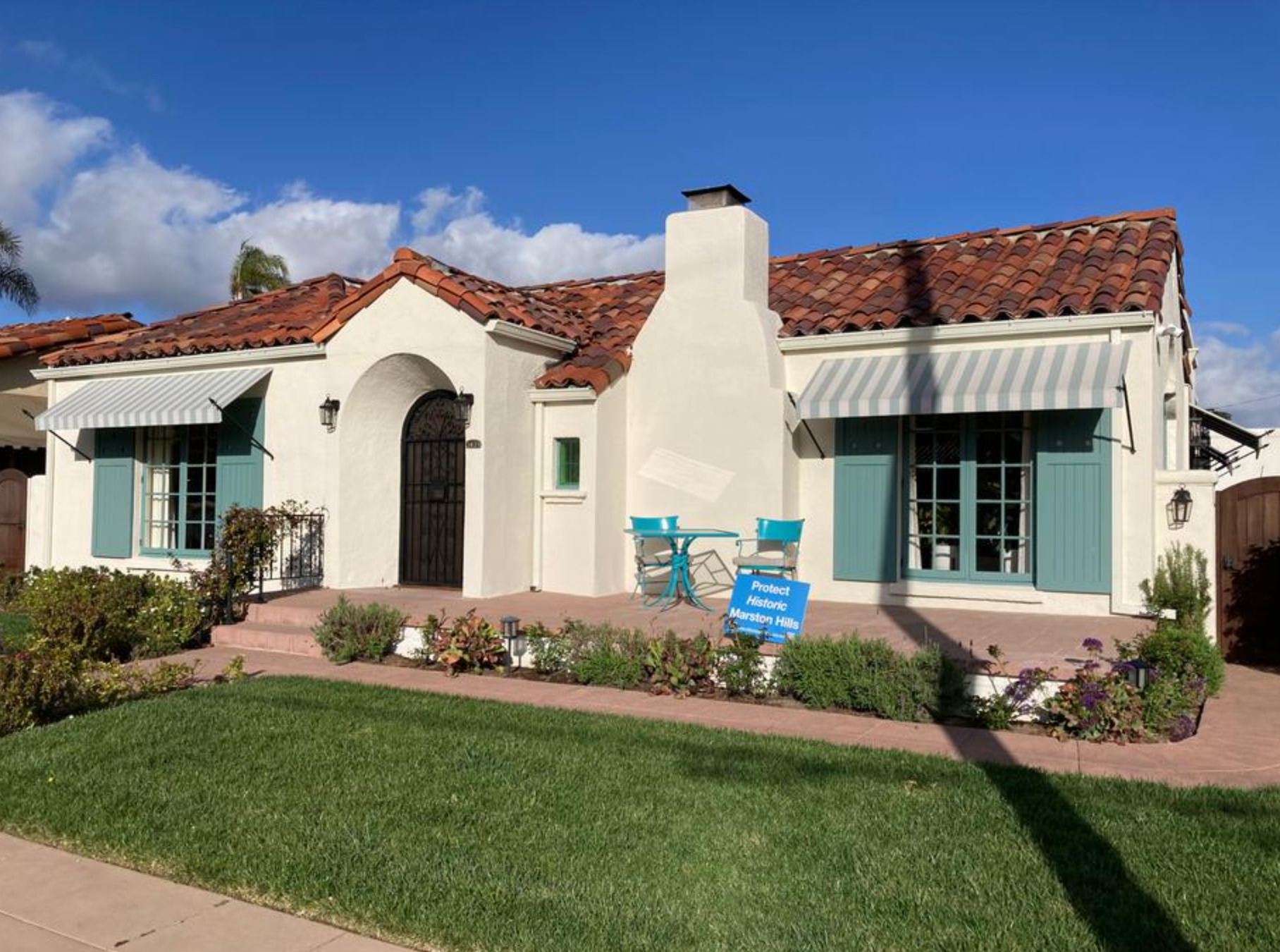 The 1925 Spanish Colonial Revival Hurlburt and Tifal house at 3431 Vermont Street in Marston Hills, San Diego, with its restored entry gable, red tile roof, and striped awnings