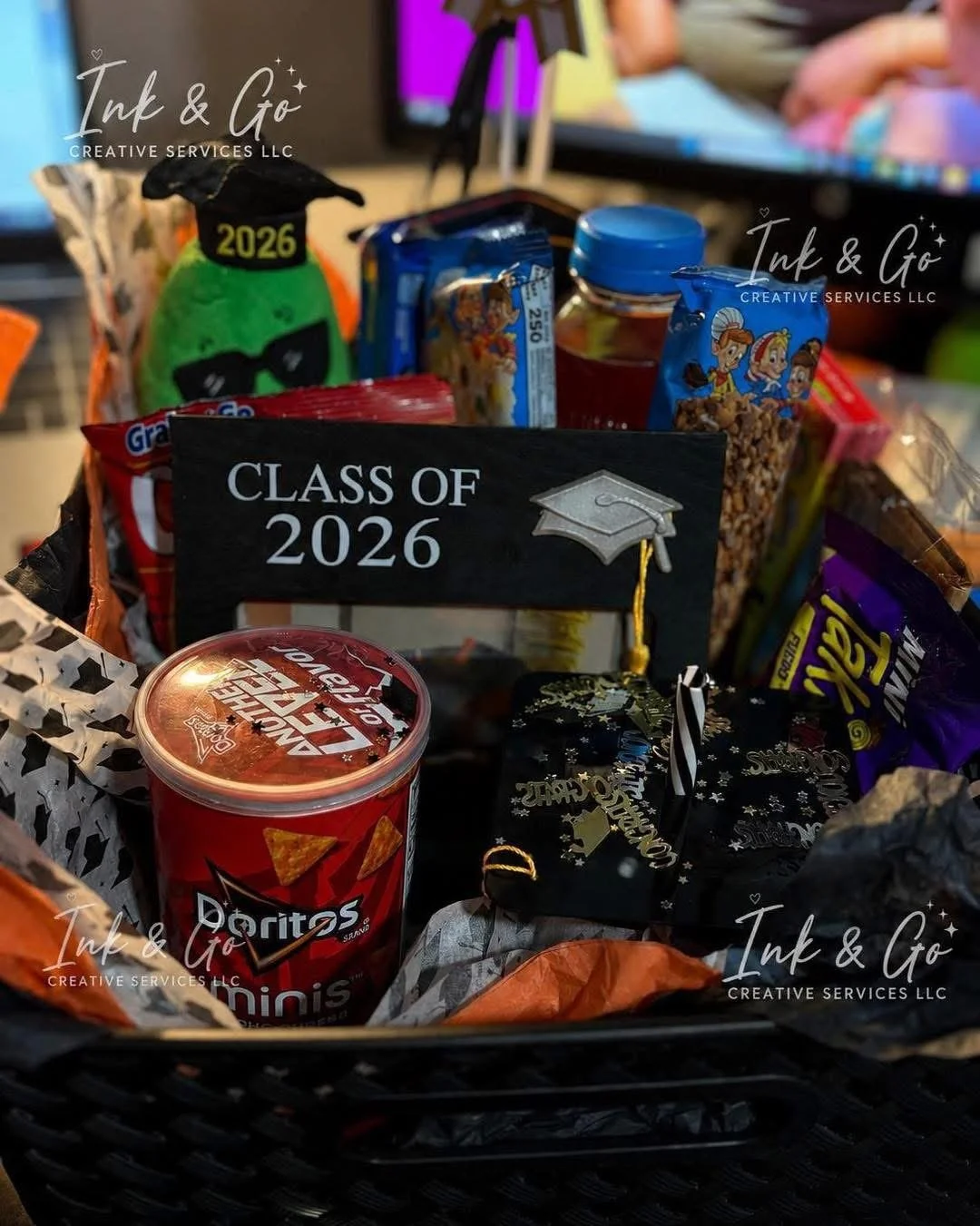 Custom graduation gift basket filled with snacks, treats, and personalized graduation-themed items.