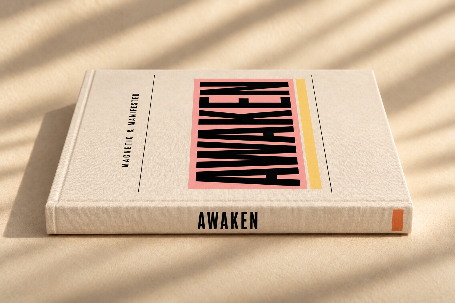 A book titled "AWAKEN" with the subtitle "MAGNETIC & MANIFESTED" on a beige surface with shadows.
