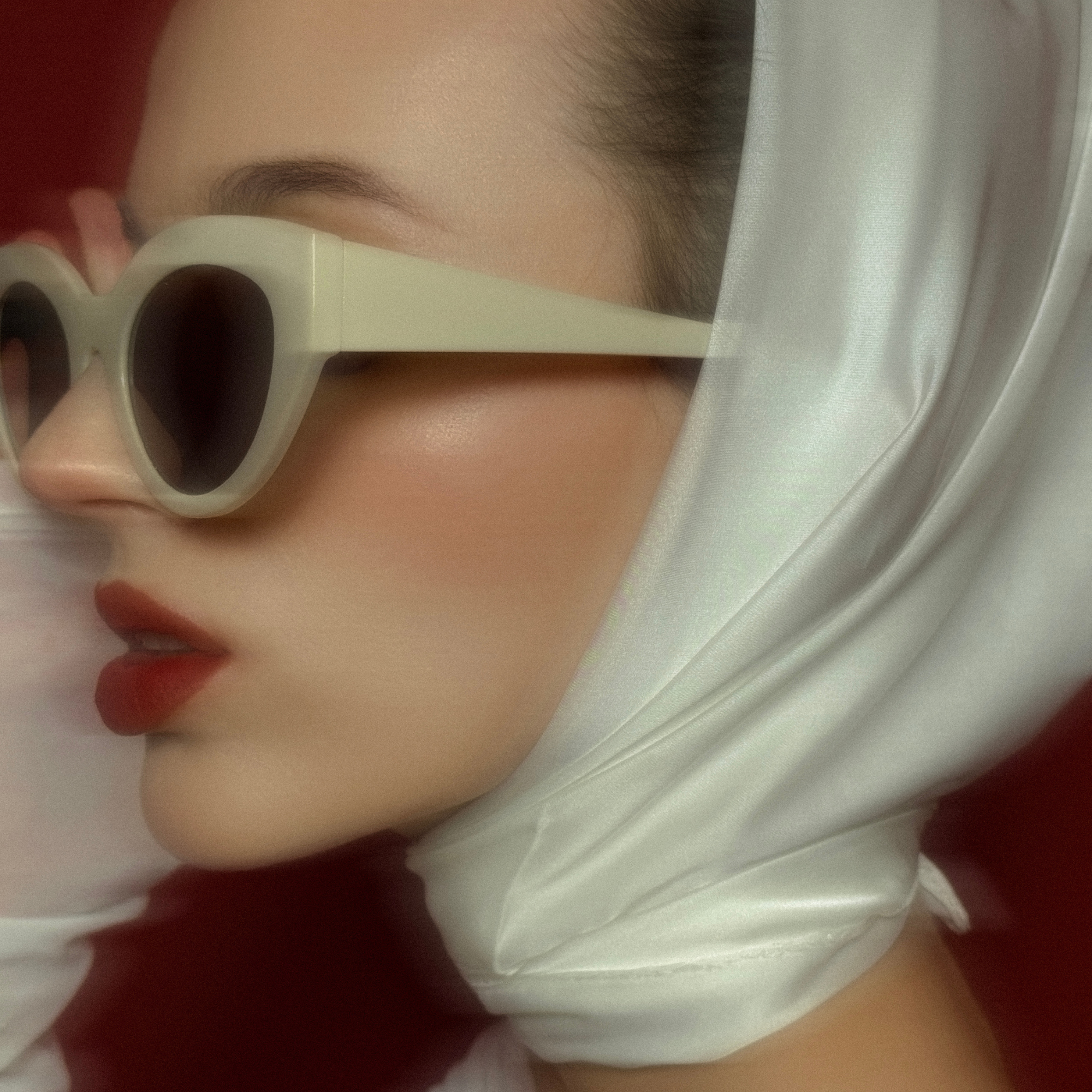 motion blur photo of woman in sunglasses in scarf