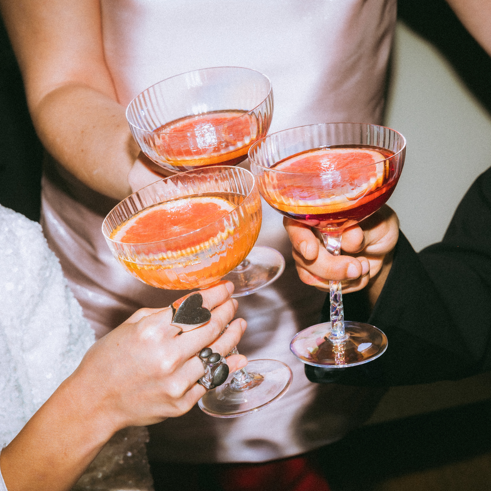 editorial three girls toasting glasses
