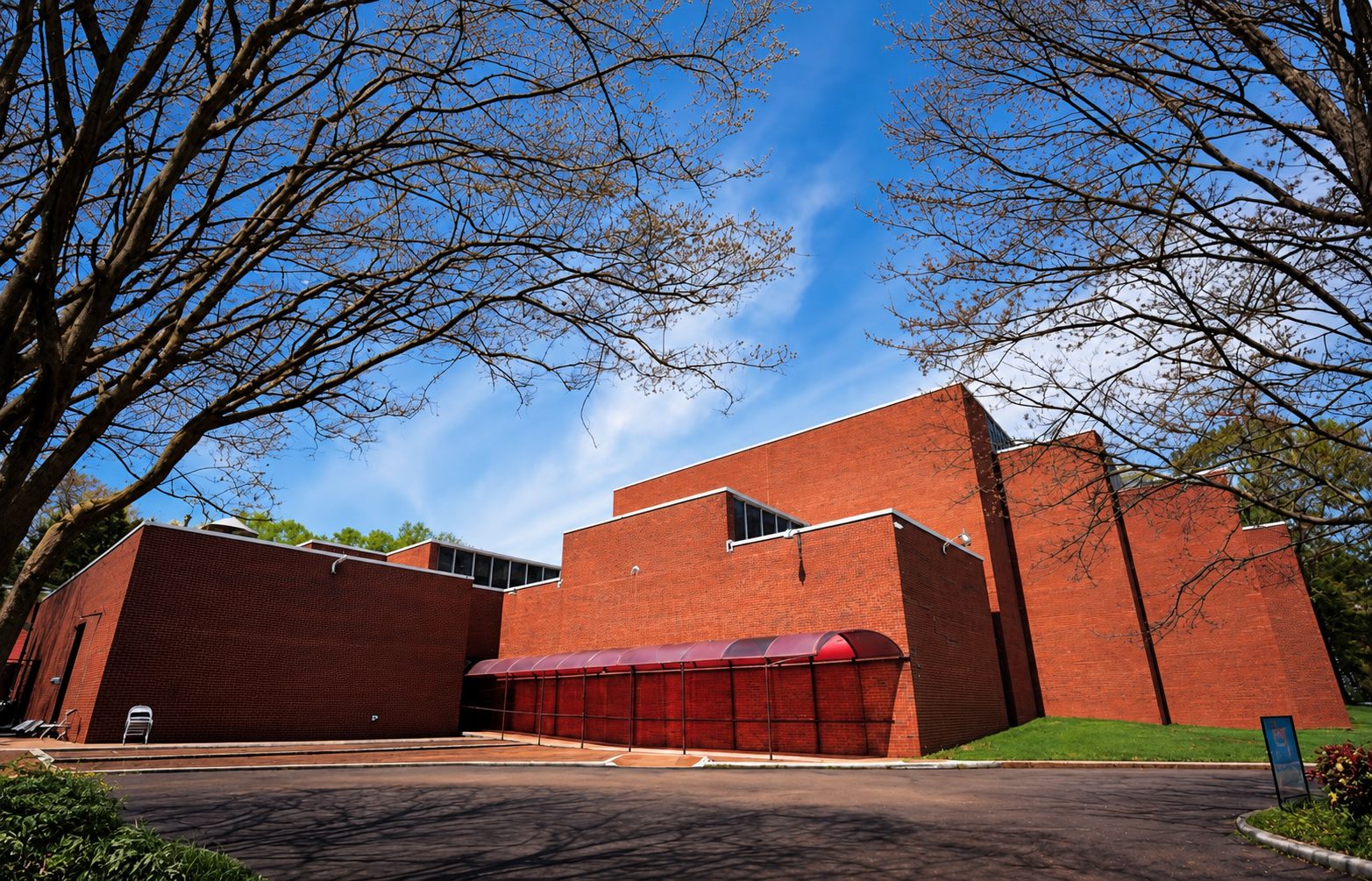 Brutalist Brick Building Beneath Spring Branches.png