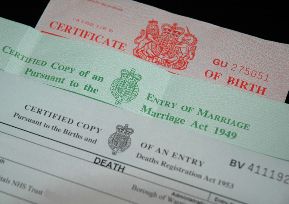 UK birth certificate with green and red text, official seal, and coat of arms.