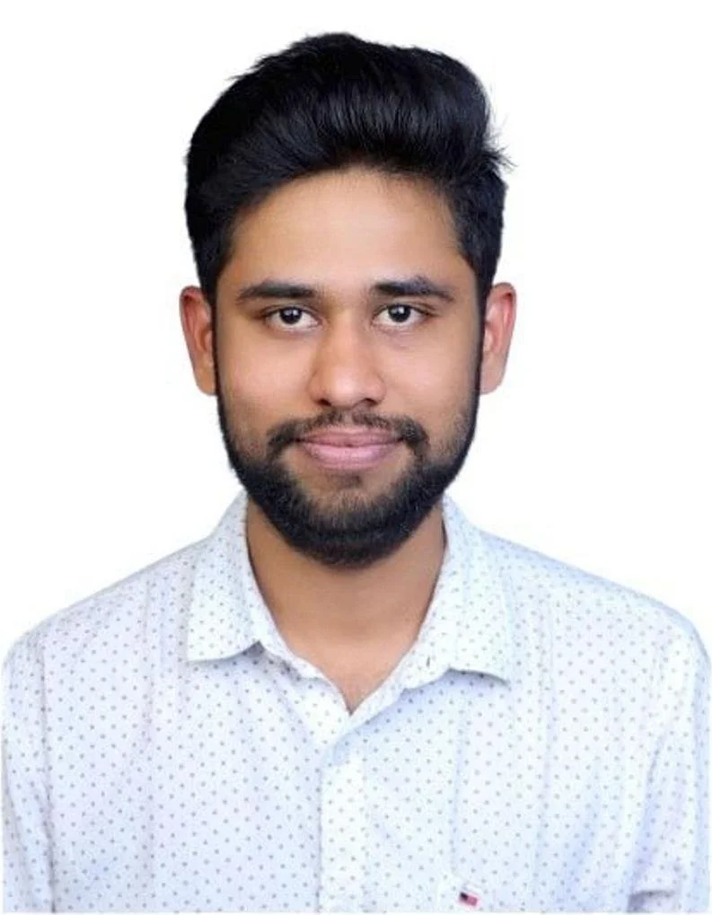 Portrait of a young man wearing a white shirt.