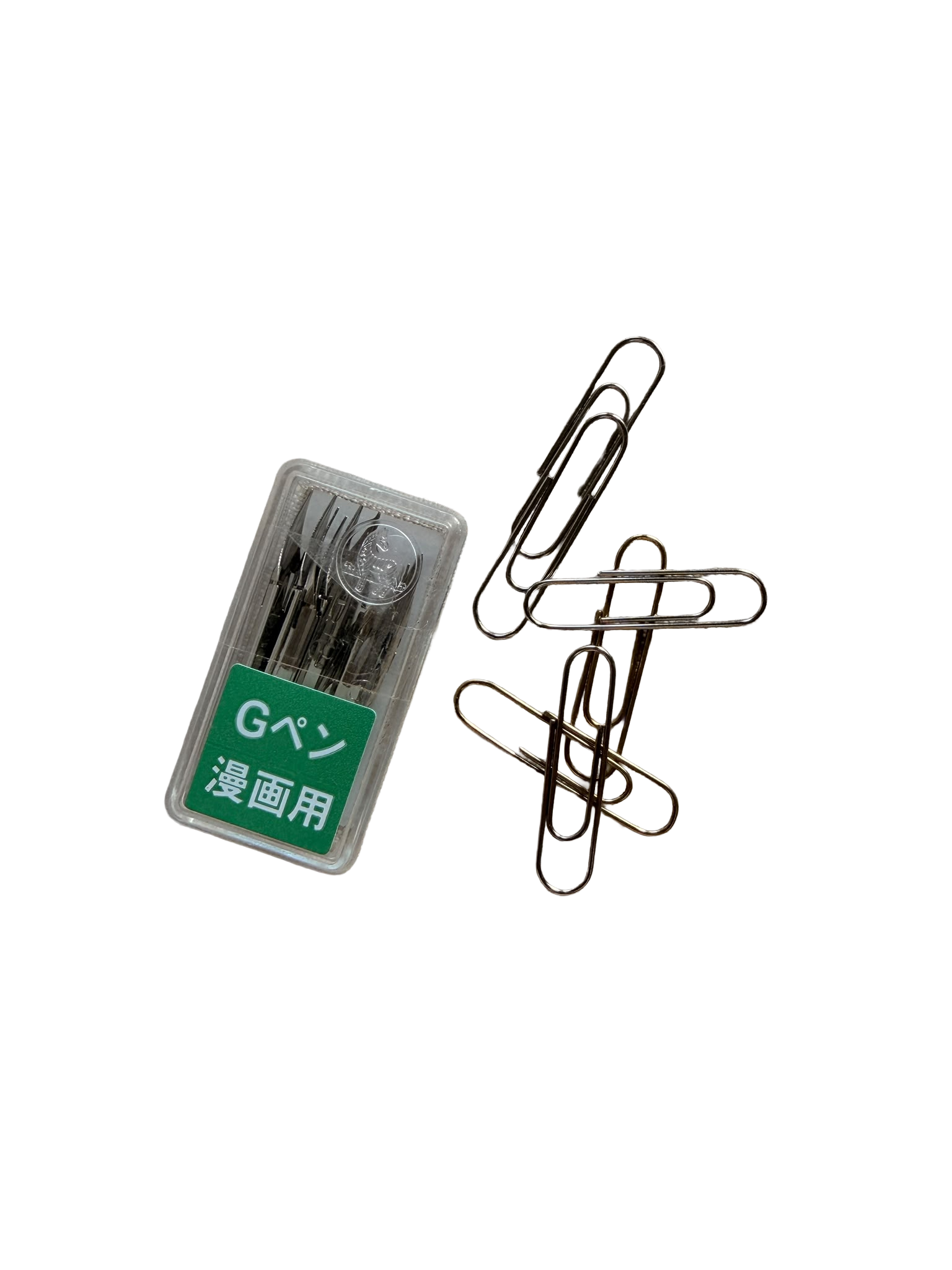 A set of metal sewing needles in a plastic case with green and white Japanese labeling, a metal paperclip, and a metal jewelry or craft-making clip on a black background.