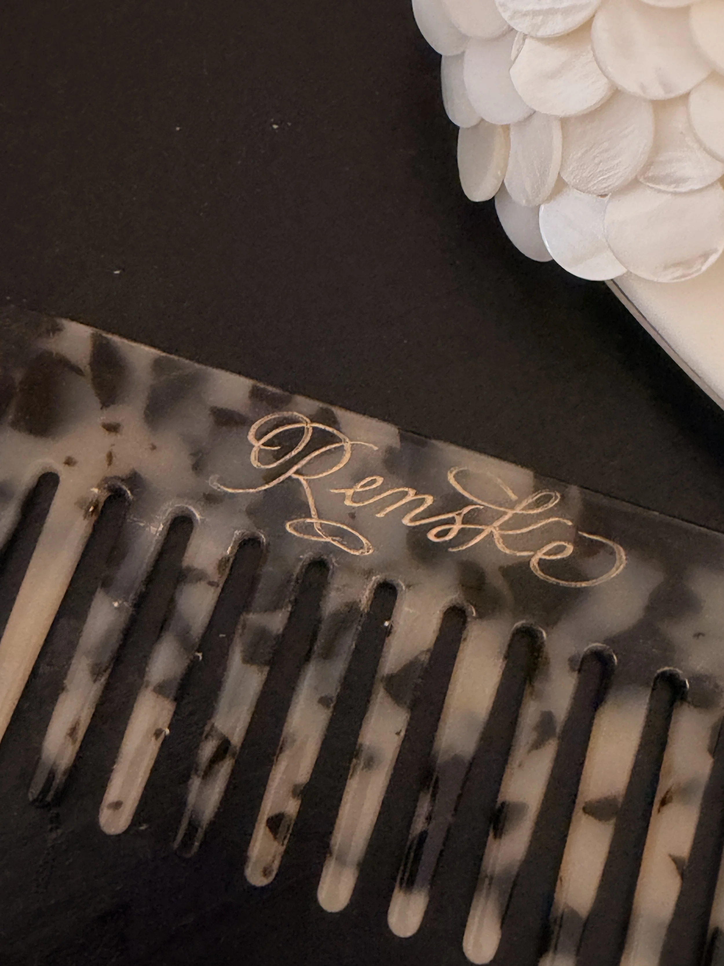 Close-up of a comb being personalised by hand at the Nakd pop-up