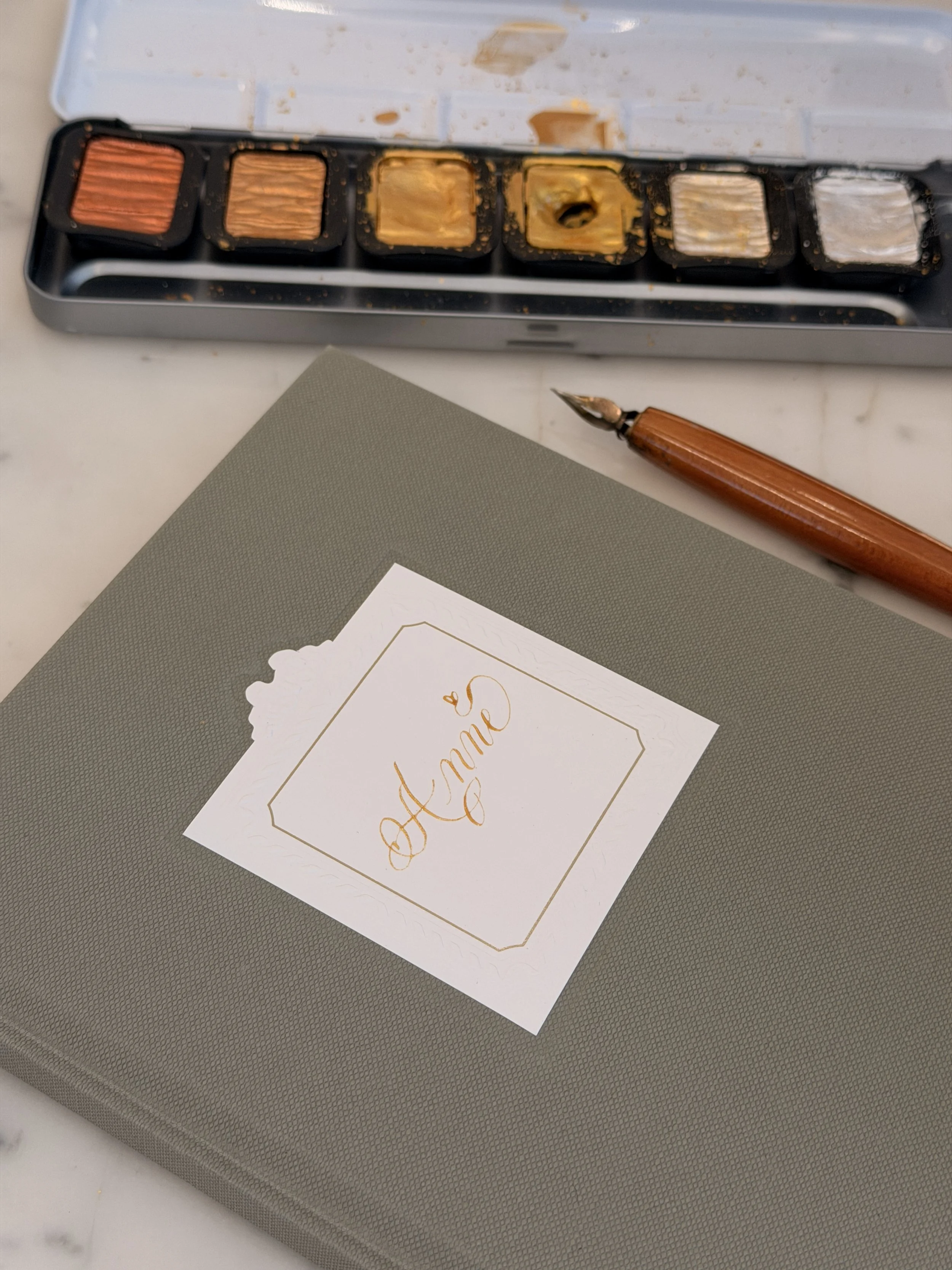 Gold calligraphy in a Dior Notebook