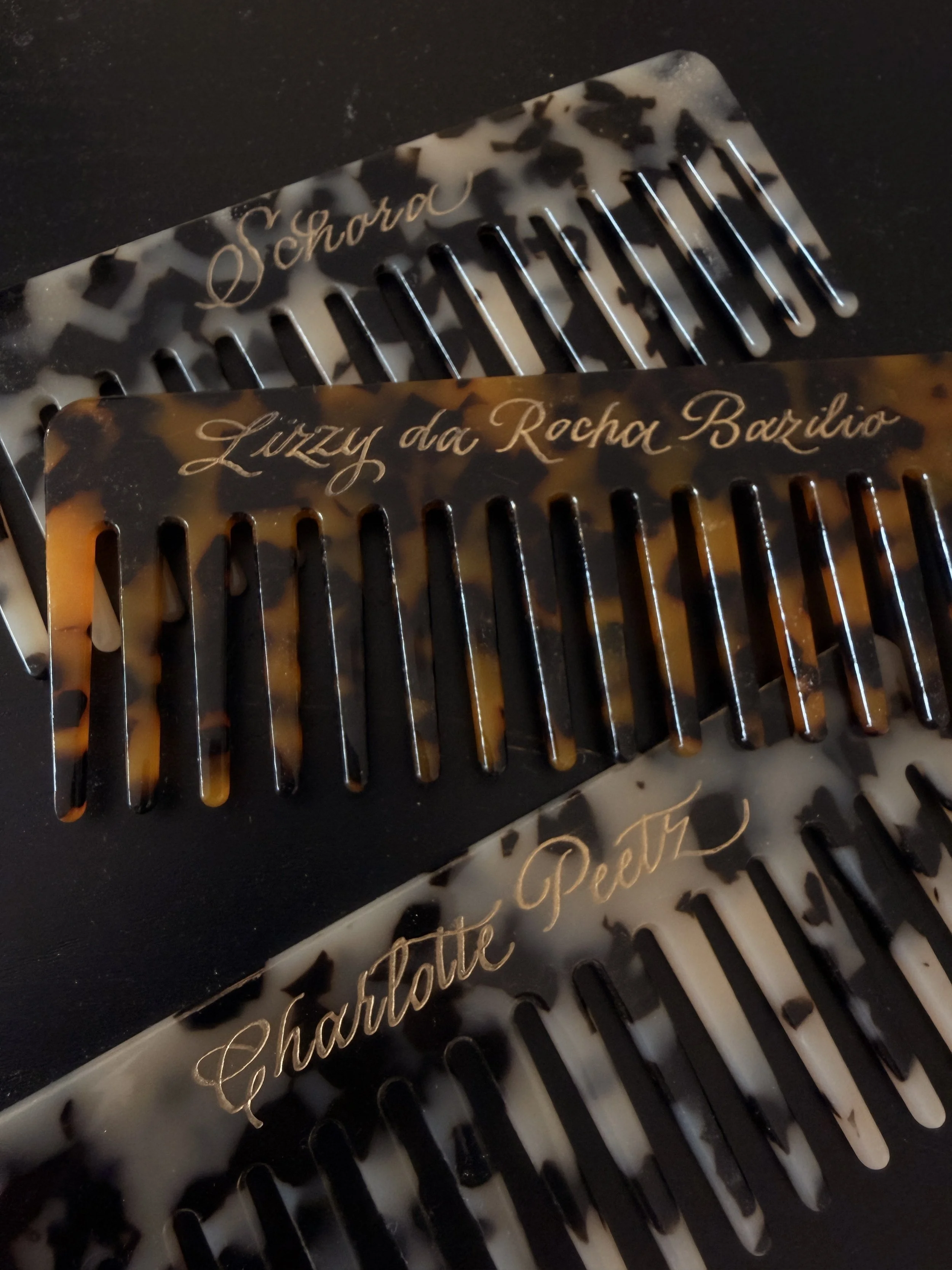 Two hair combs with the names in calligraphy engraved for Nakd Pop up in Amsterdam