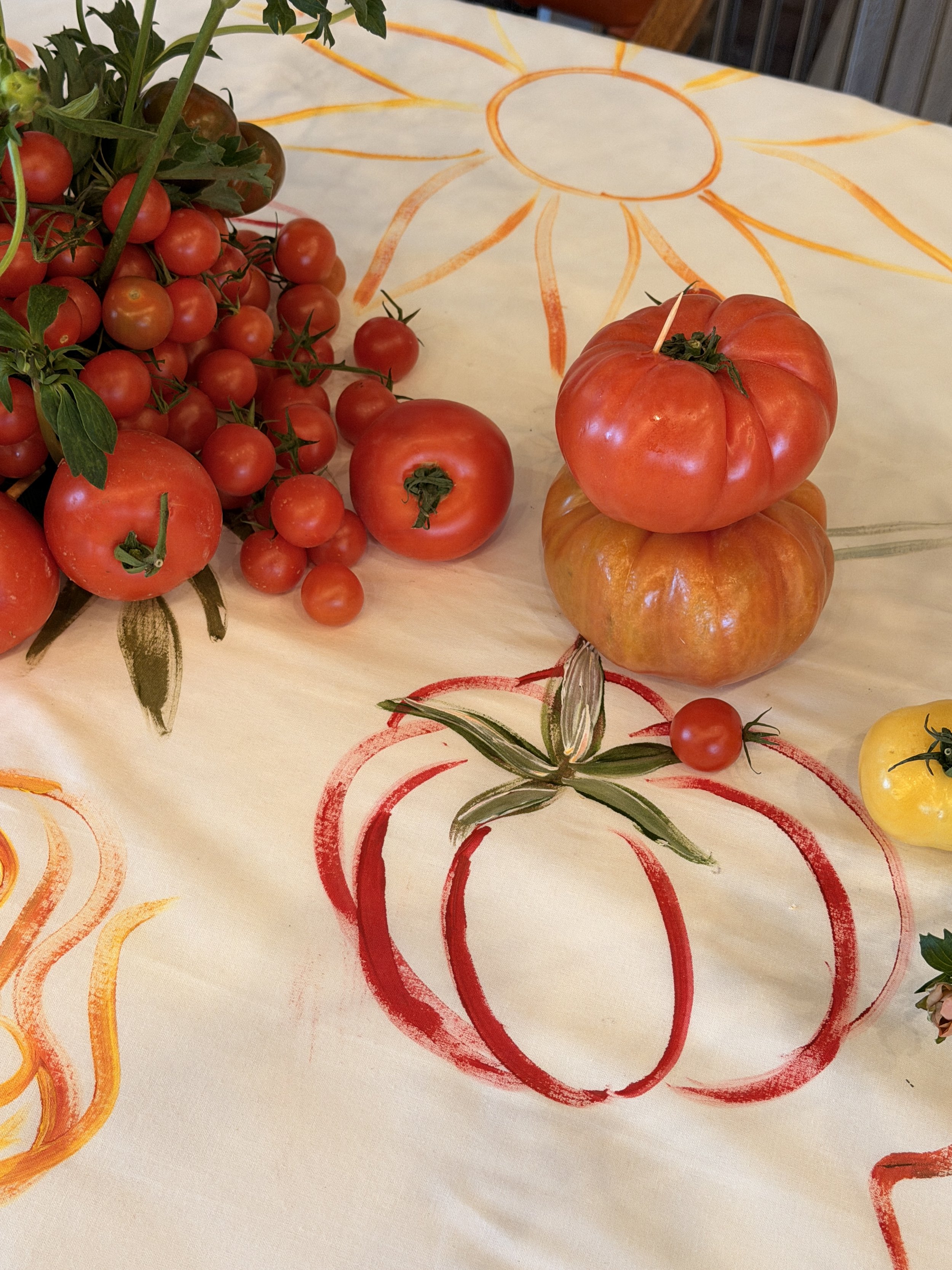 Hand-painted linen details paired with tableware for a bespoke event