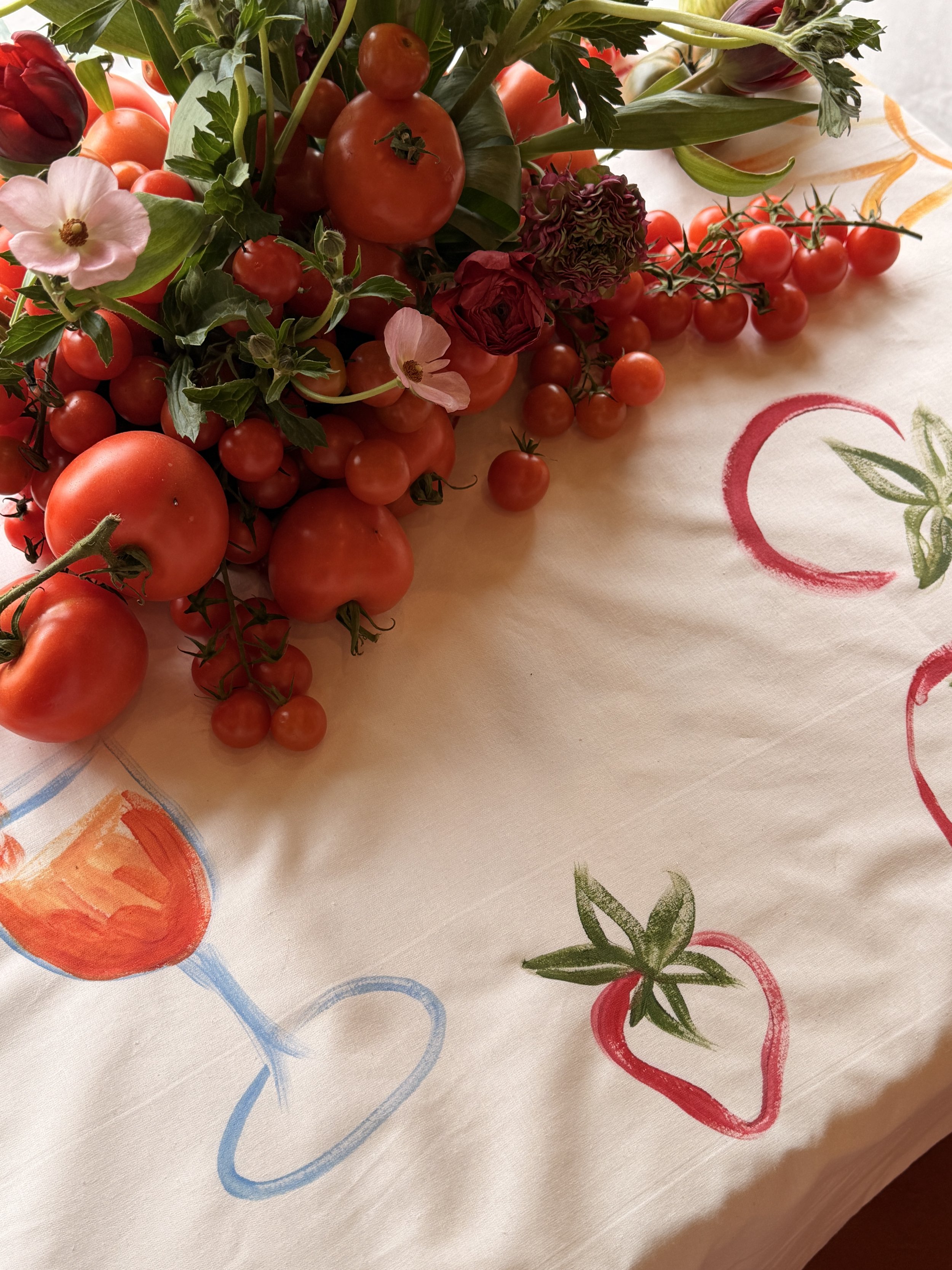 Close-up of Italian-inspired hand-painted motifs on an event tablecloth