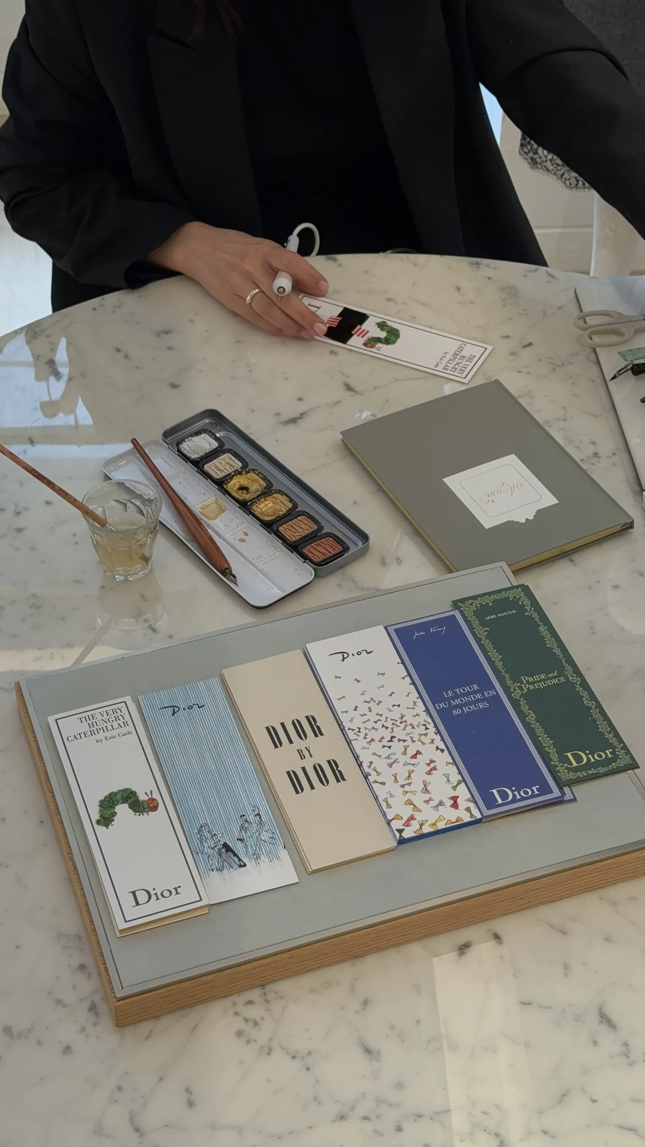 Live calligrapher personalising stationery at a brand activation in Dior Dam Amsterdam