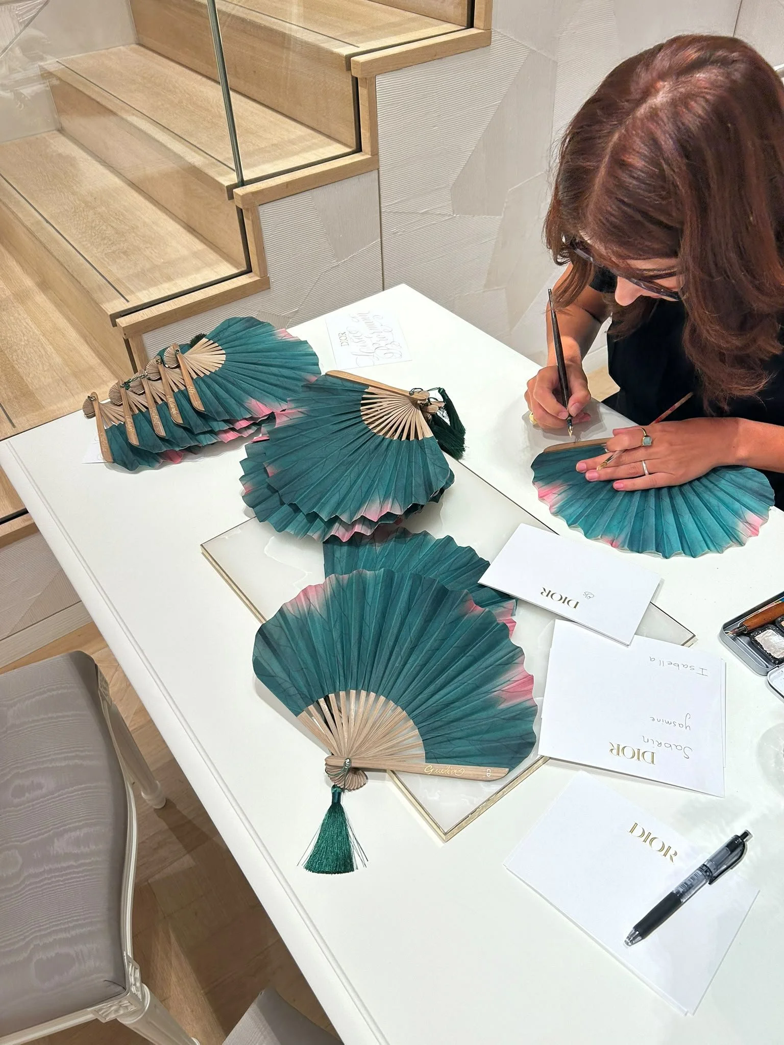 Live engraving in personalised fans for a luxury brand event - Dior, in PC Hoofstraat in Amsterdam.