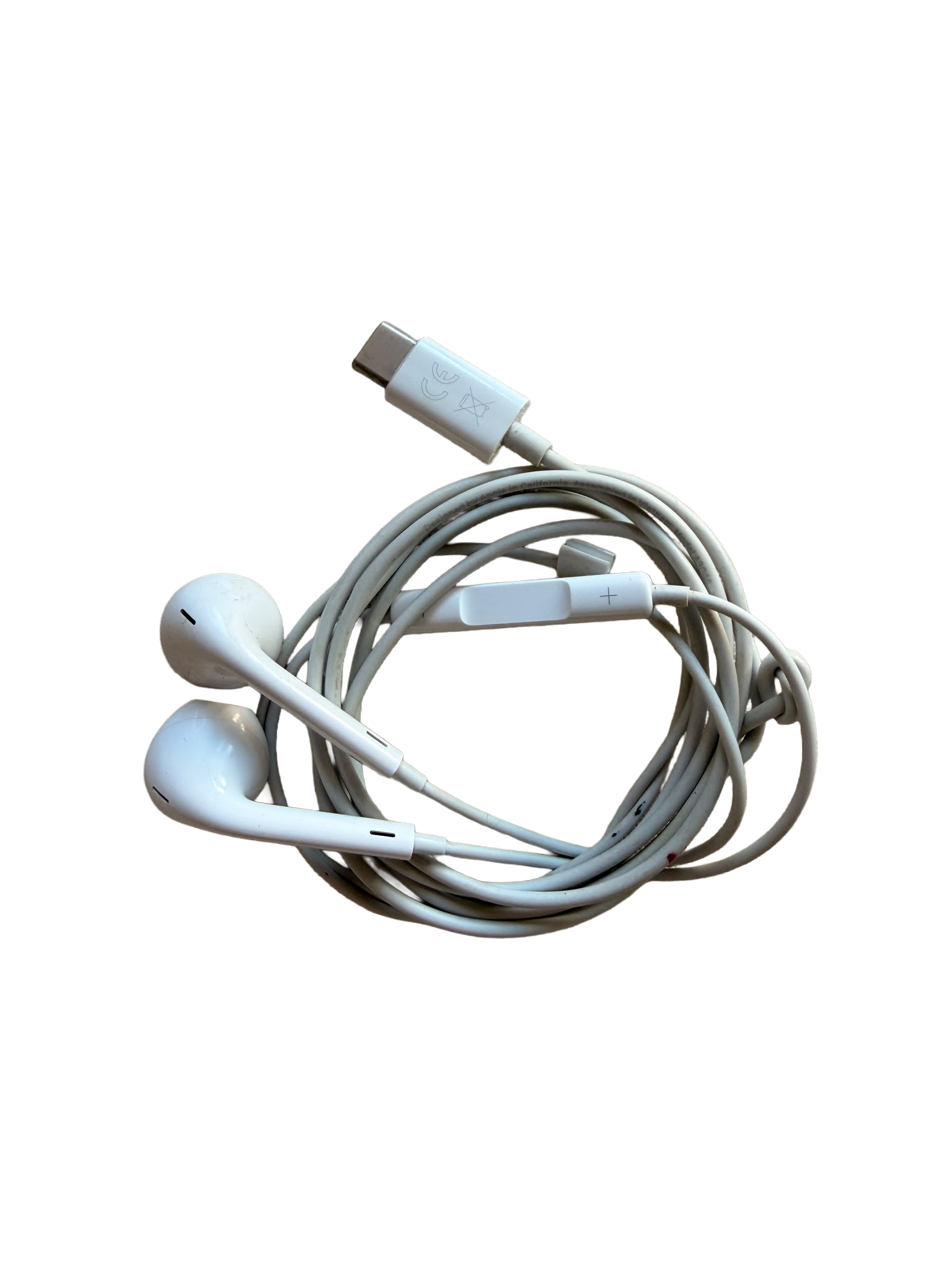 White earphones and charging cable on a black surface.