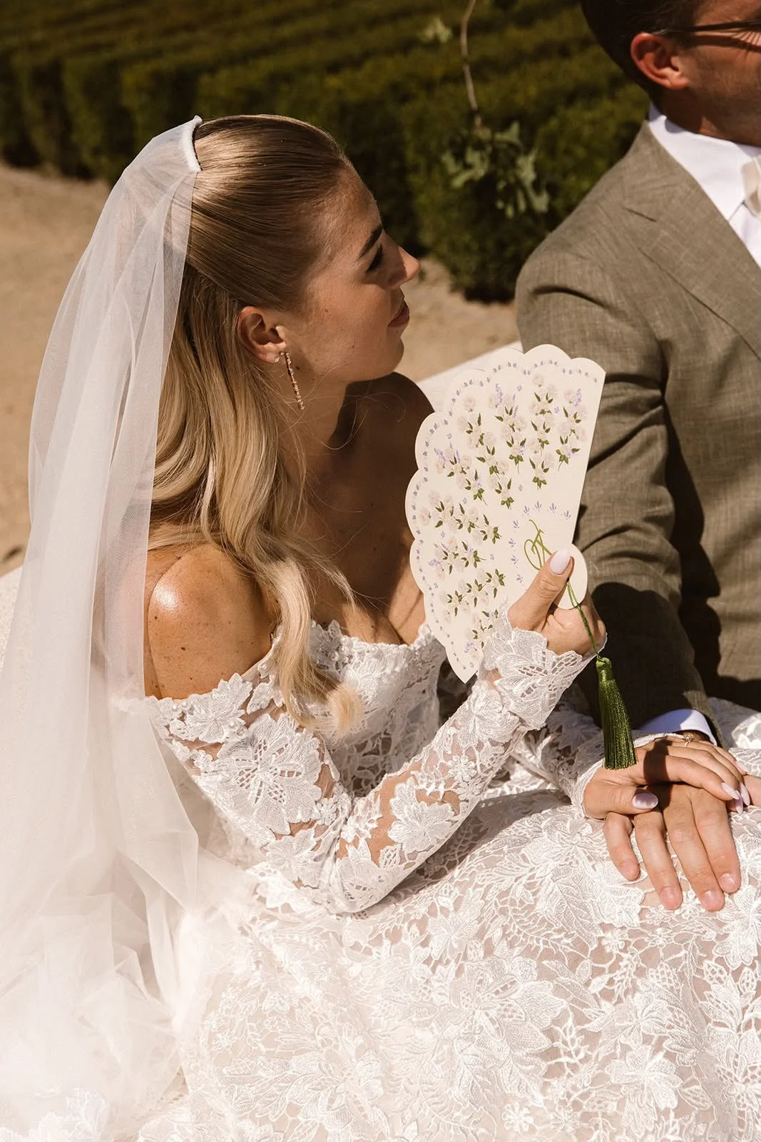 Victoria Verstappen holding a bespoke fan for her wedding ceremony, designed by Gaia.