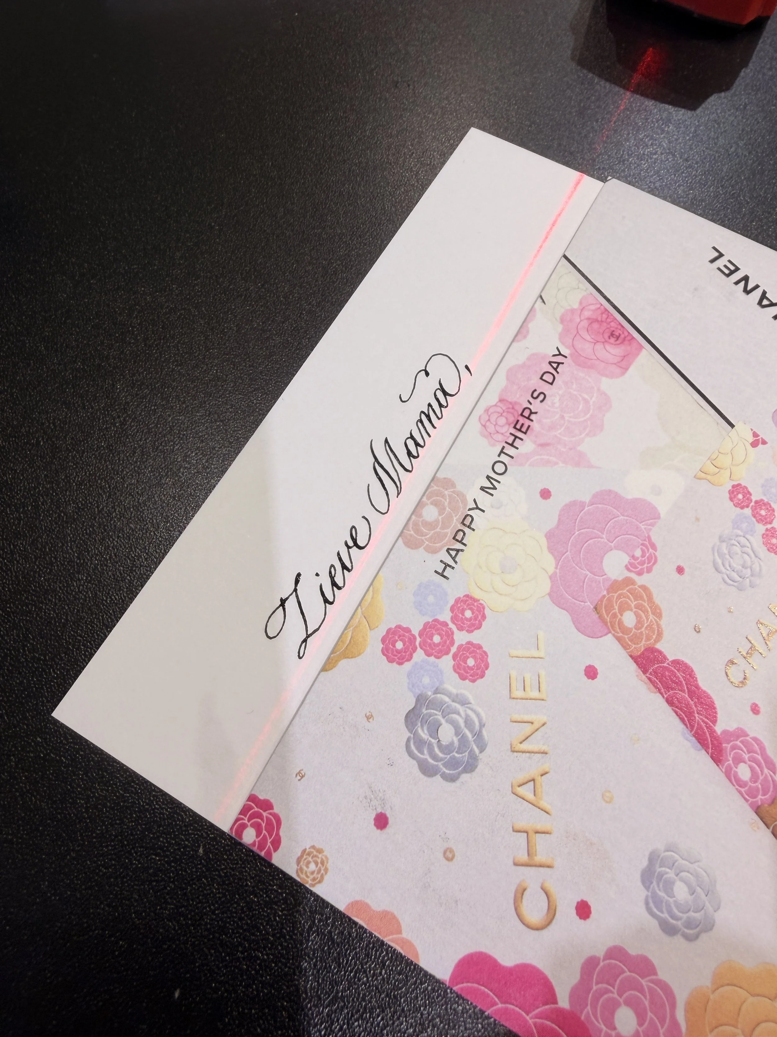 A Mother's Day card with pink and purple floral designs and a calligraphy message by Gaia Amsterdam for Chanel Beauty